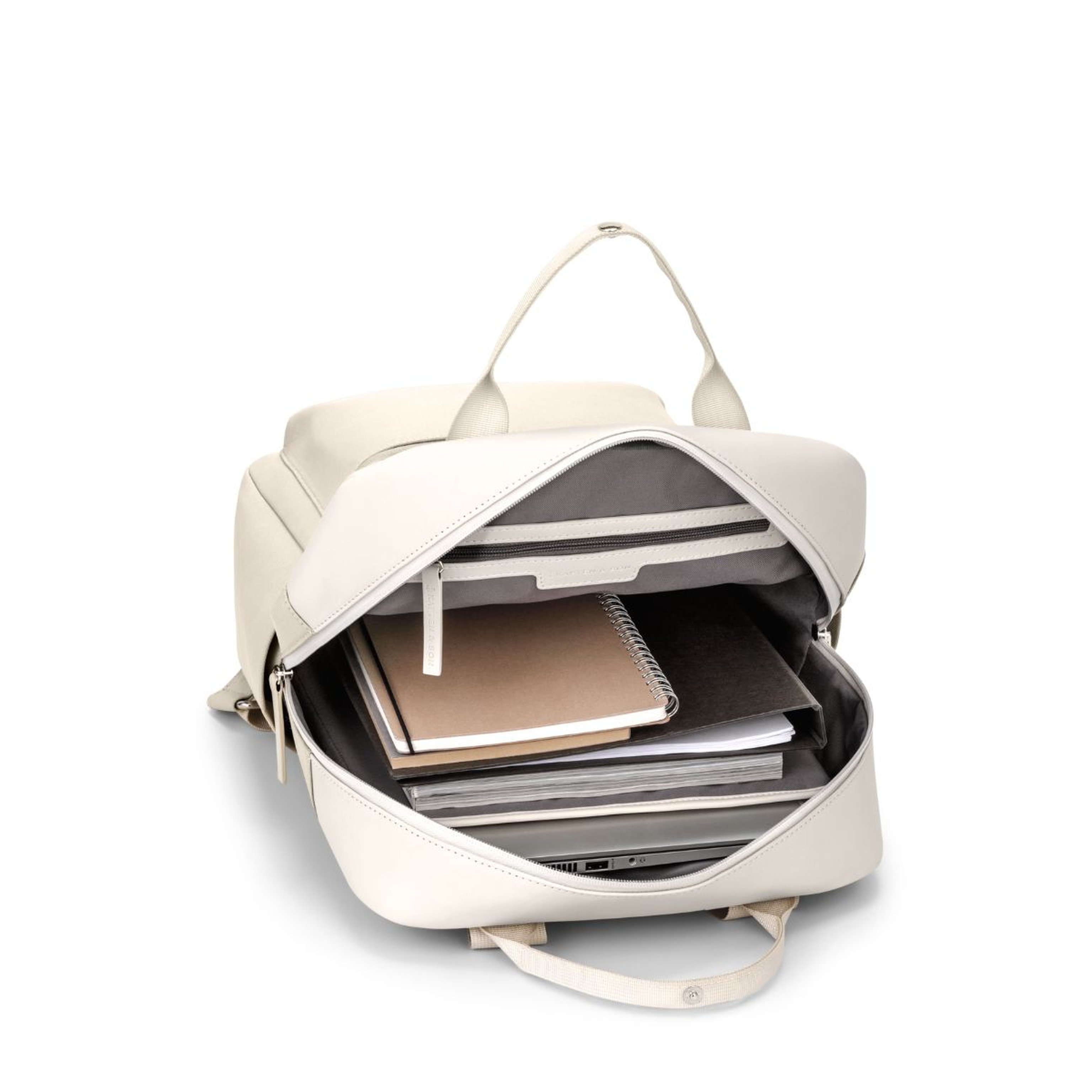 Open white backpack with a gray interior, showcasing neatly organized notebooks and folders inside, conveying a sense of preparedness and order.