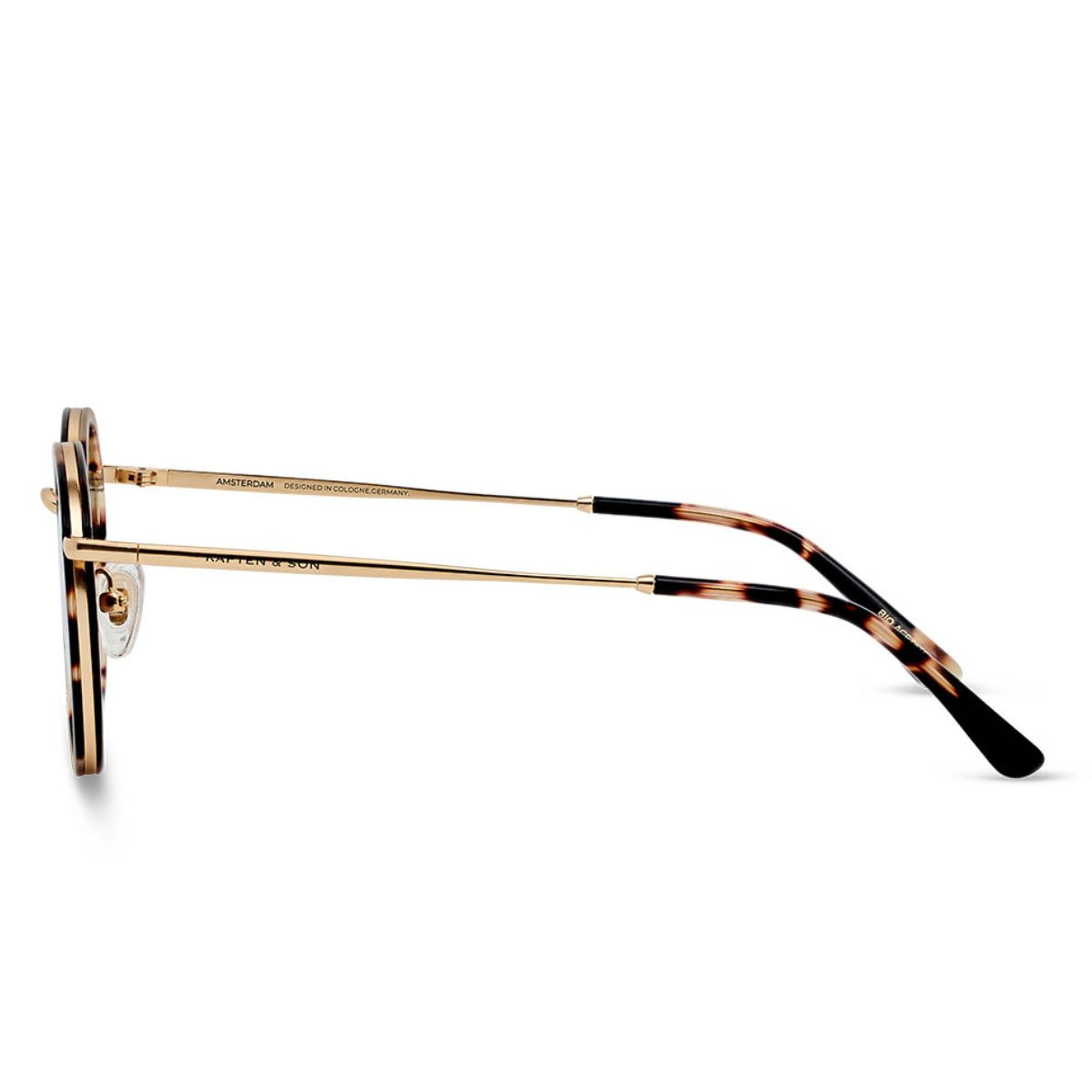 Sleek black sunglasses displayed side-on, showcasing slim arms with "Kapten & Son" branding. The design is minimalistic and modern.