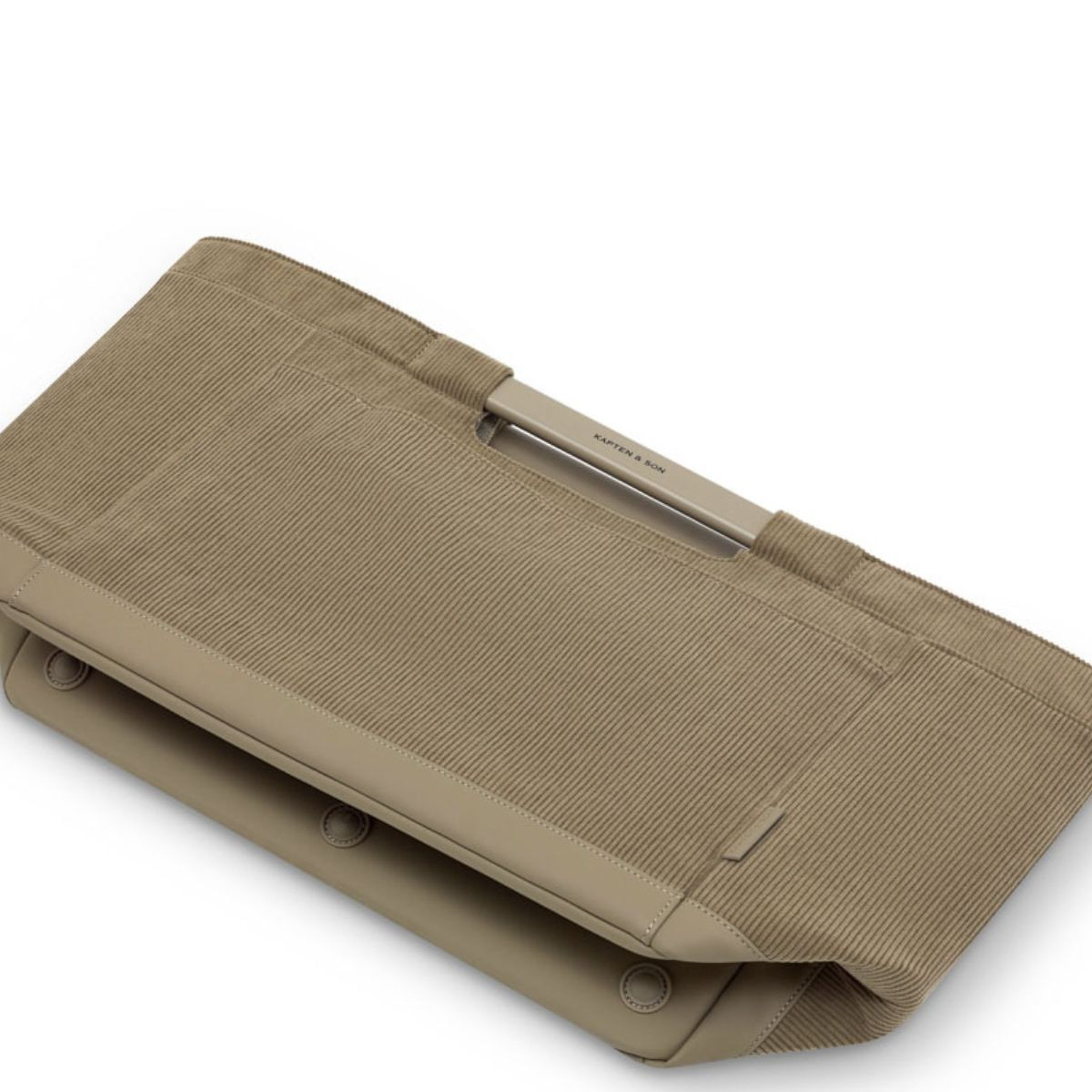 A minimalist shopping basket is shown lying flat on a white background. The bag features a sleek, structured design with clean lines and a subtle handle accent.