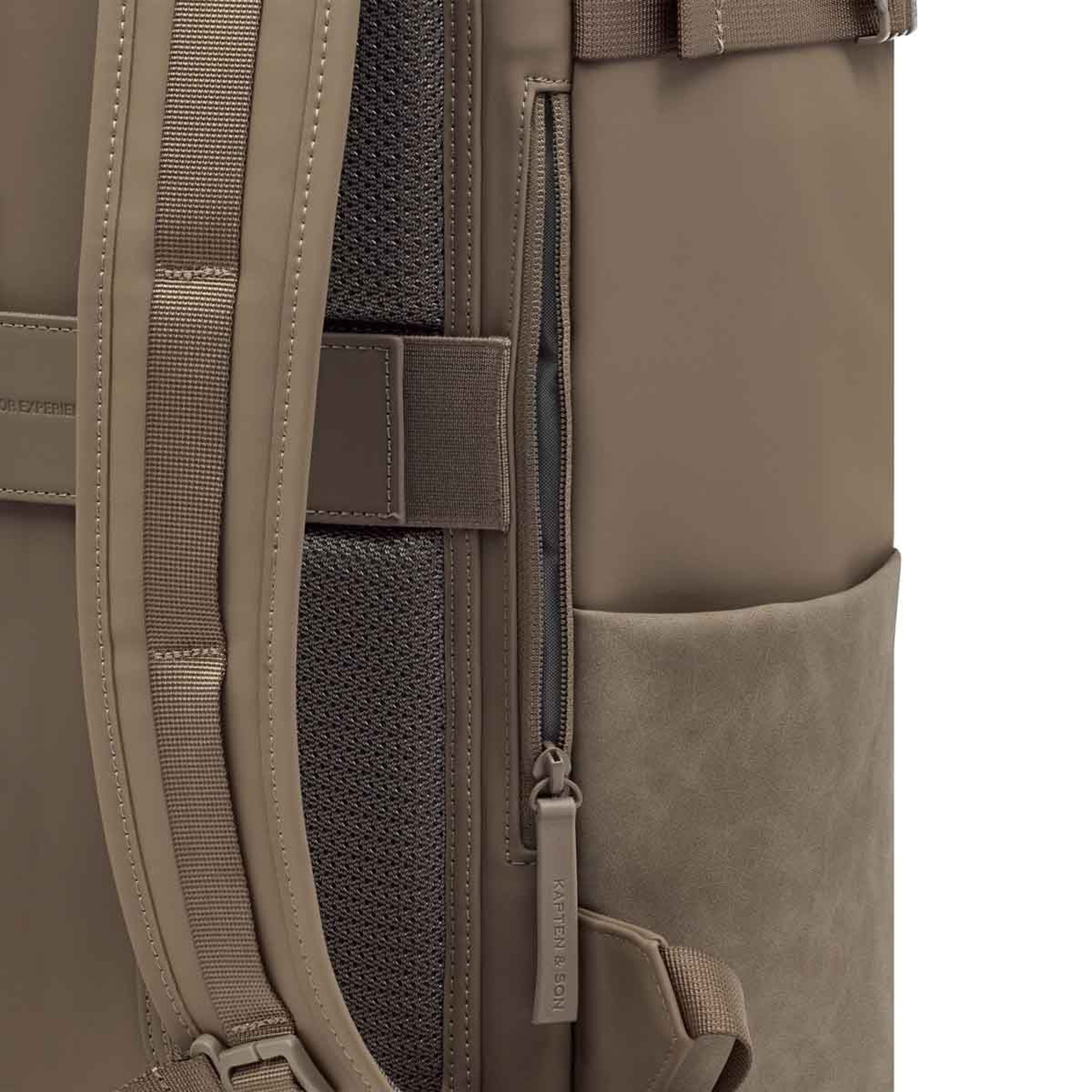 Close-up of a backpack showing a vertical side zipper with a branded pull tab, padded straps, mesh texture, and side pocket, conveying functionality.