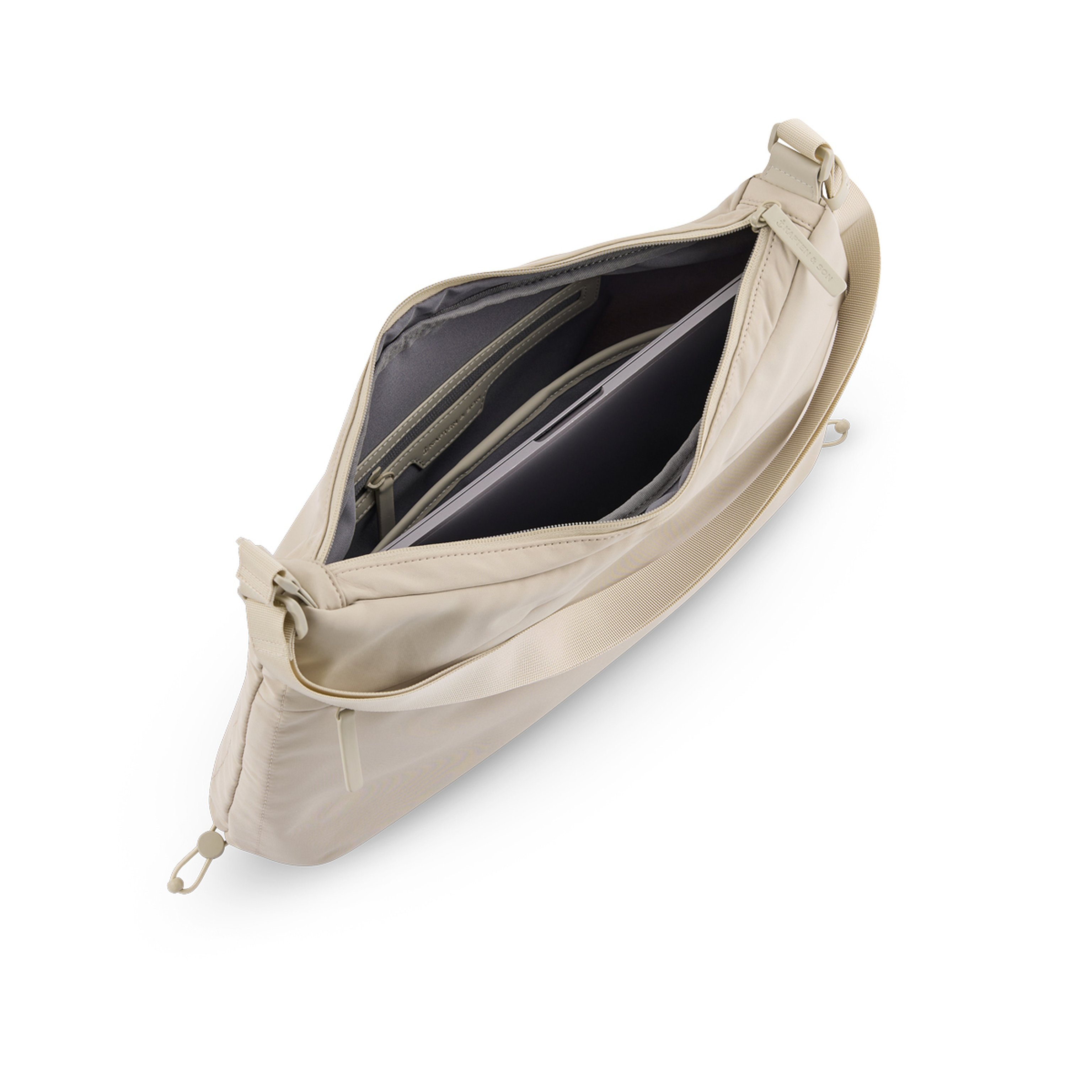 Beige crossbody bag with a top zipper, partially opened to reveal a spacious interior. Inside are a zippered pocket and a padded laptop compartment.