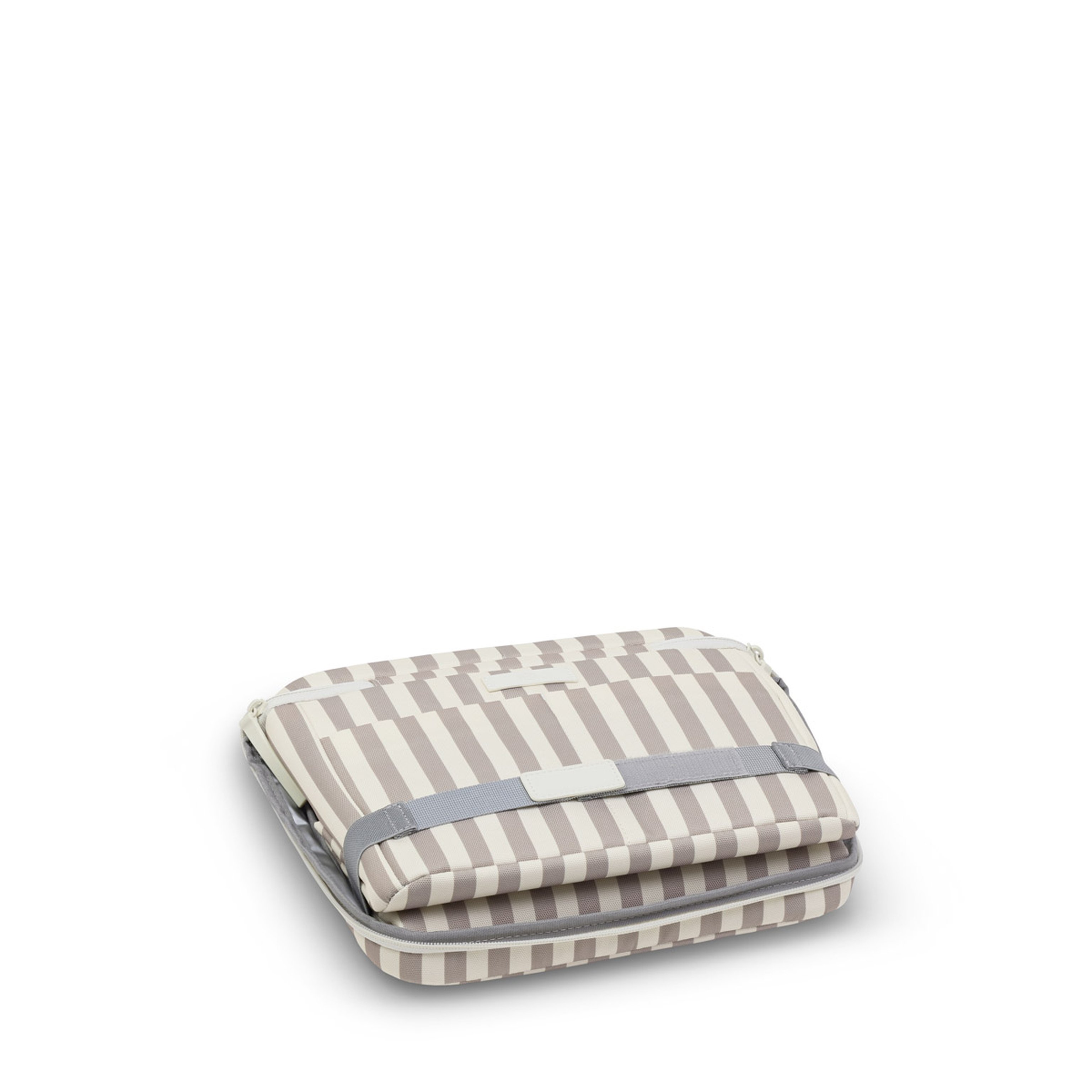 A neatly folded, striped beige and white canvas bag with a zipper and gray strap. The compact design suggests it's for easy storage or travel.