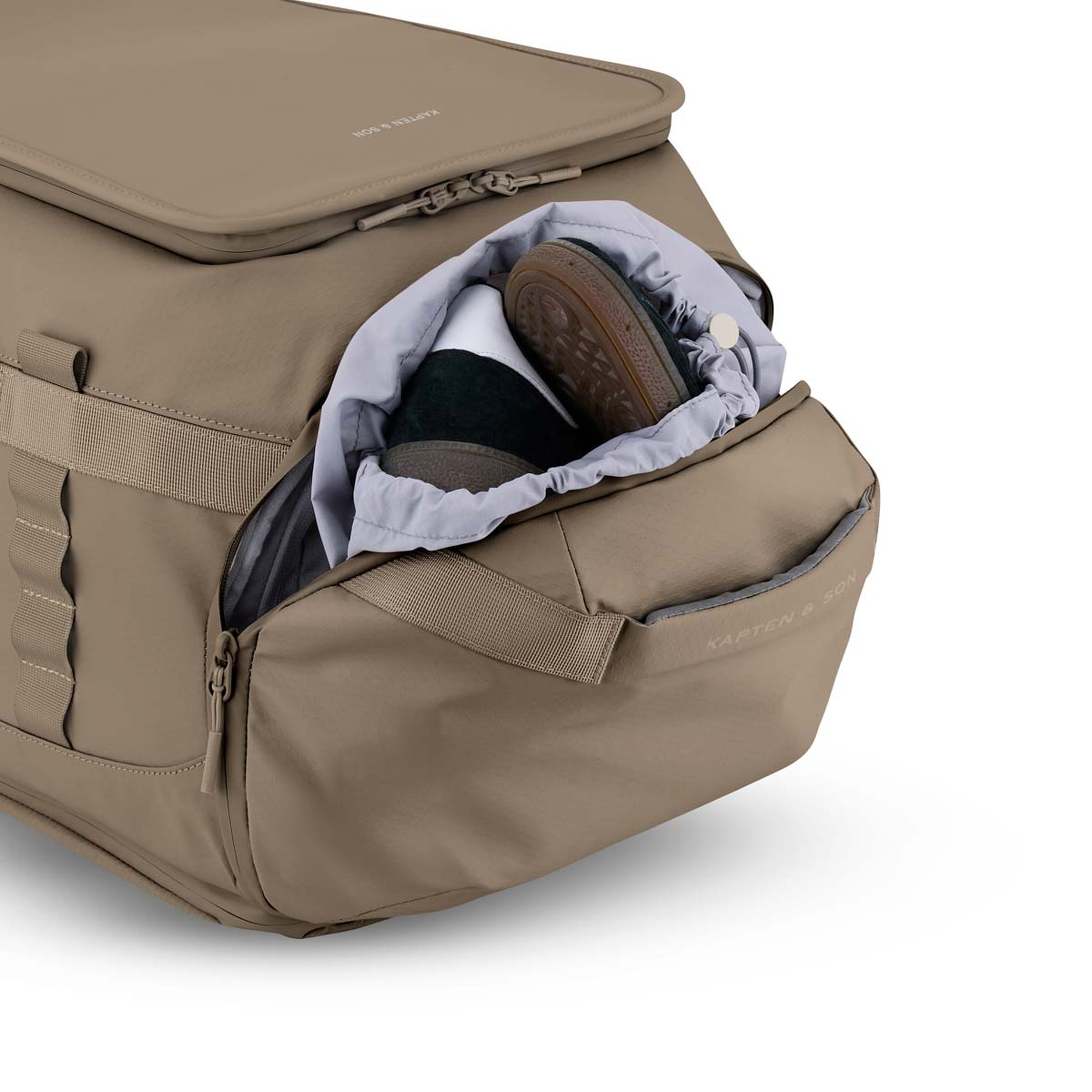 Reisetasche mit geöffnetem seitlichem Reißverschlussfach, in dem ein Paar braune Schuhe zu sehen ist. Die Tasche hat robuste Griffe und ein elegantes Design.