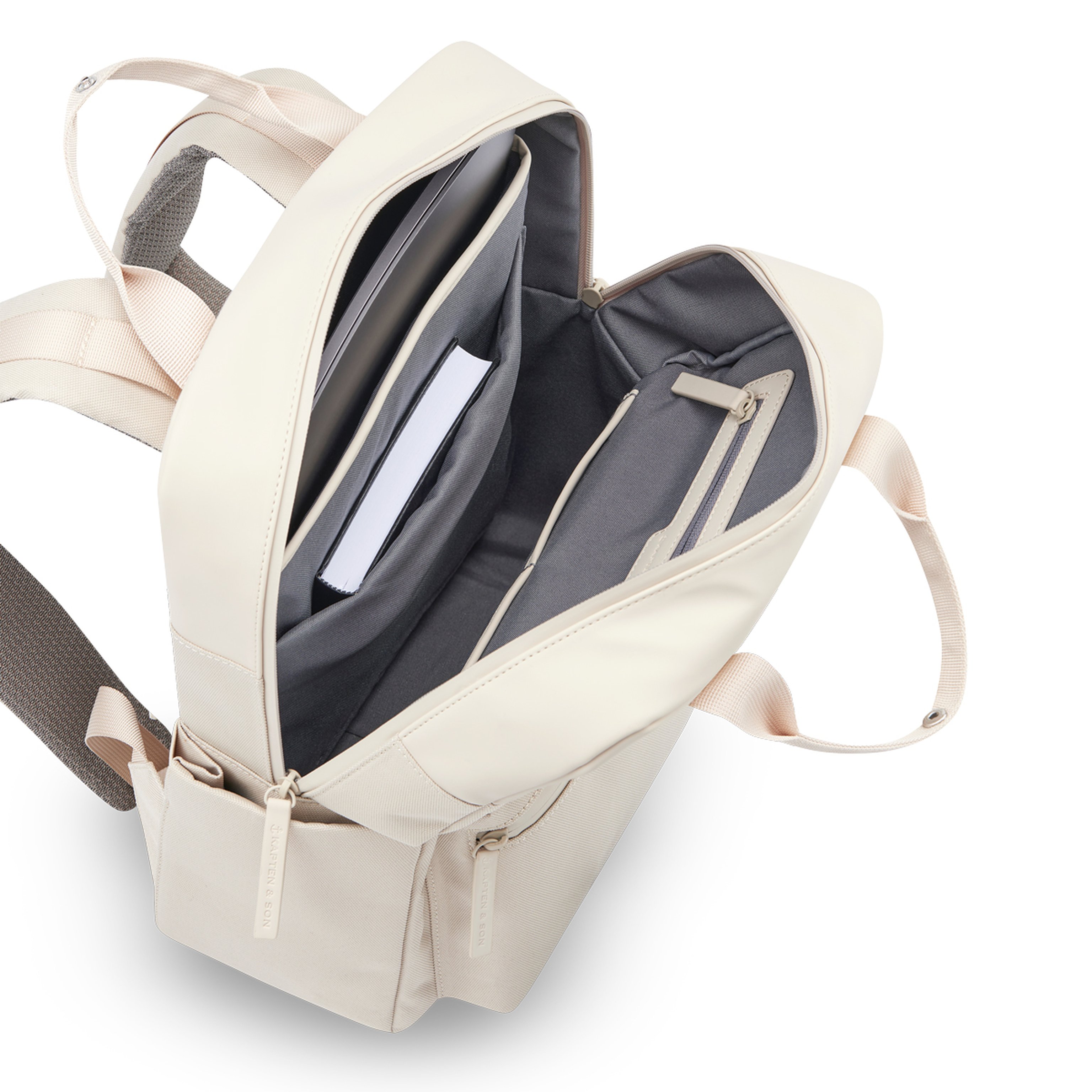Open beige backpack with laptop and book inside. Features a gray interior, multiple compartments, and sturdy beige straps. Clean, organized, and practical design.