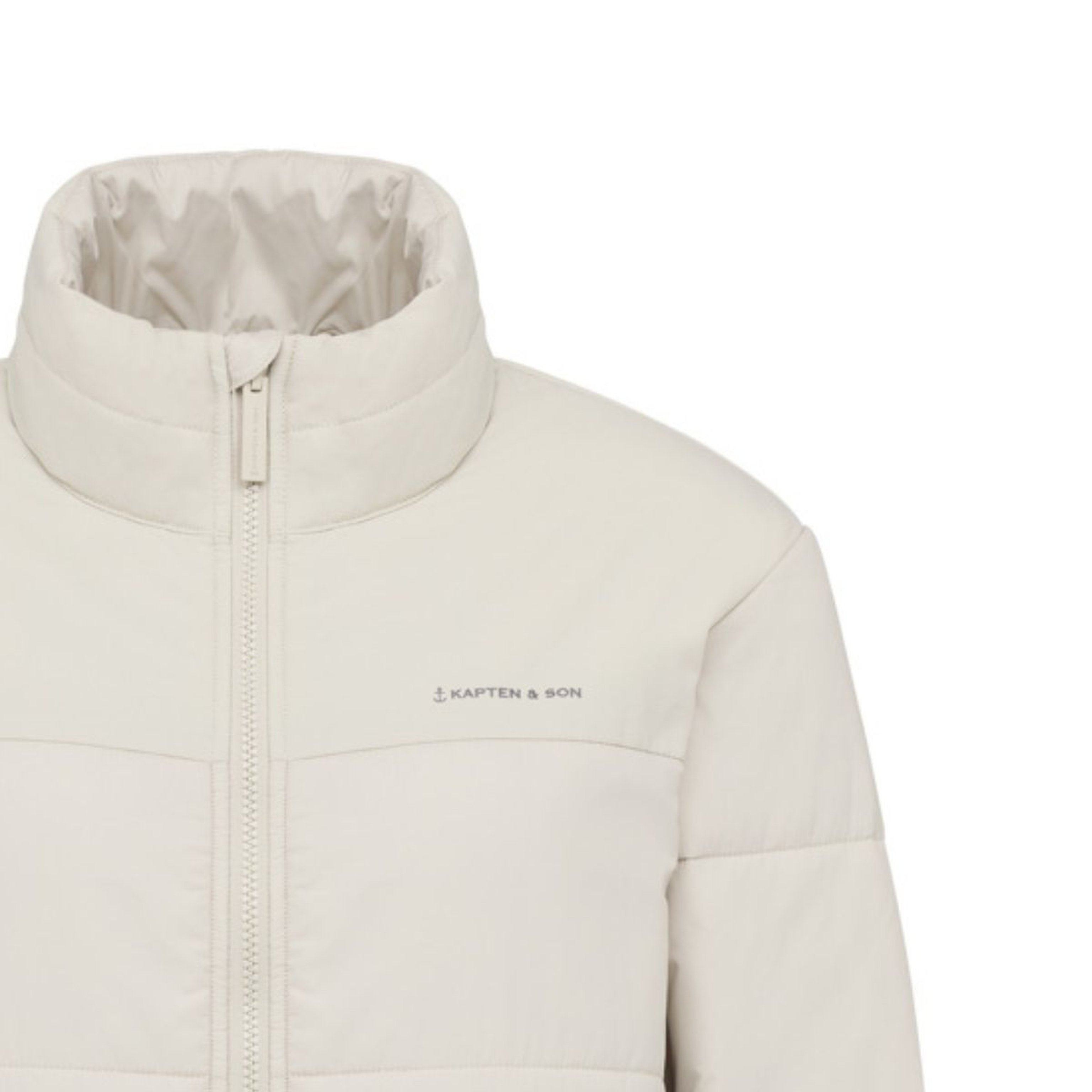 A minimalist cream-colored puffer jacket with a high collar and central zipper. It has subtle branding on the chest, conveying a sleek, modern style.