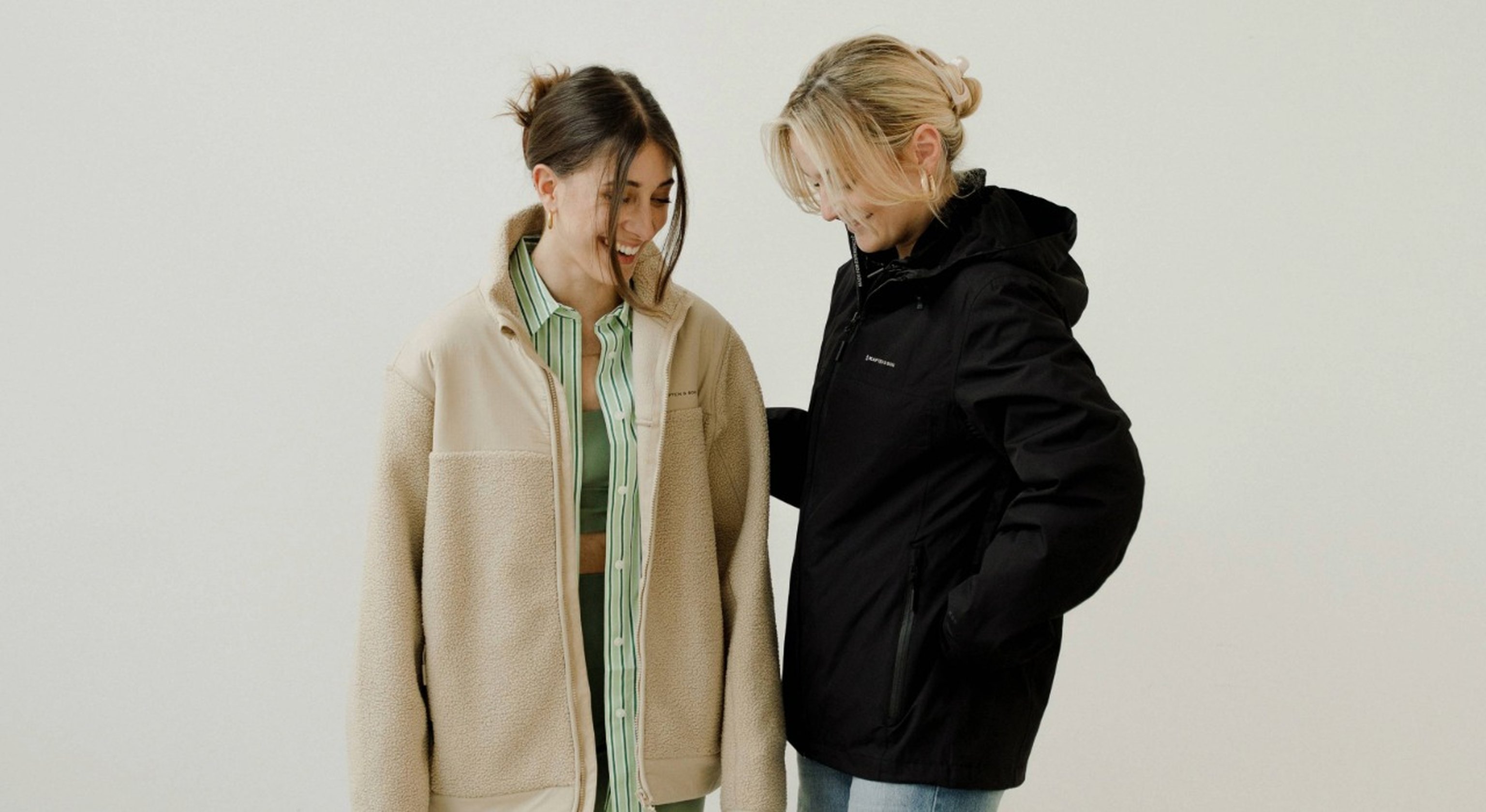 zwei junge frauen tragen kapten and son fleece und regenjacke