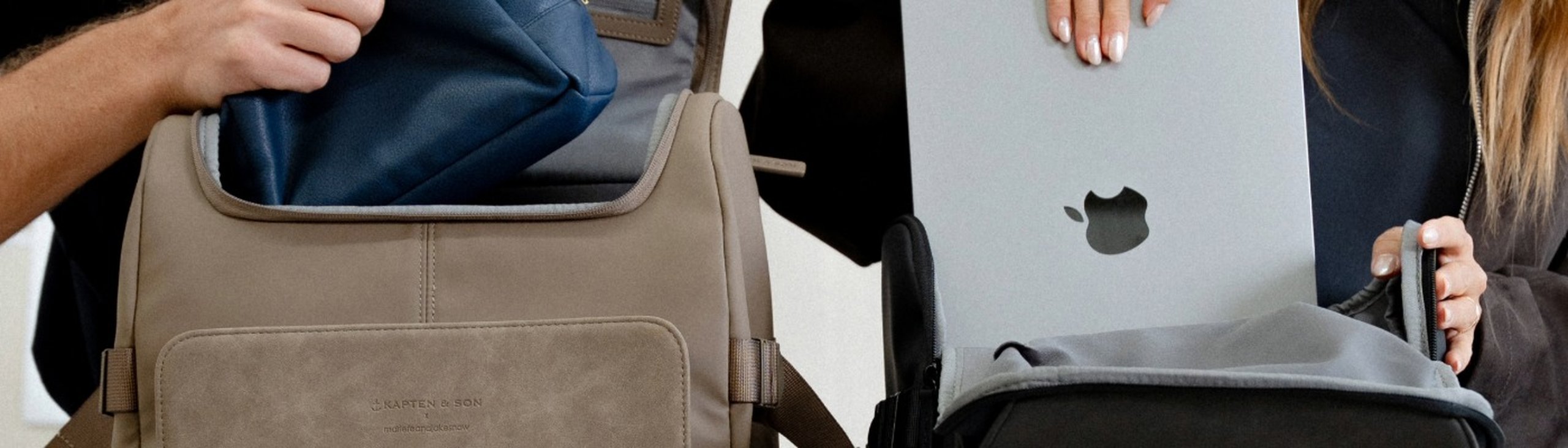 frau und man packen ihren rucksack. frau schiebt ihr macbook ins fach ihres kapten and son laptoprucksacks