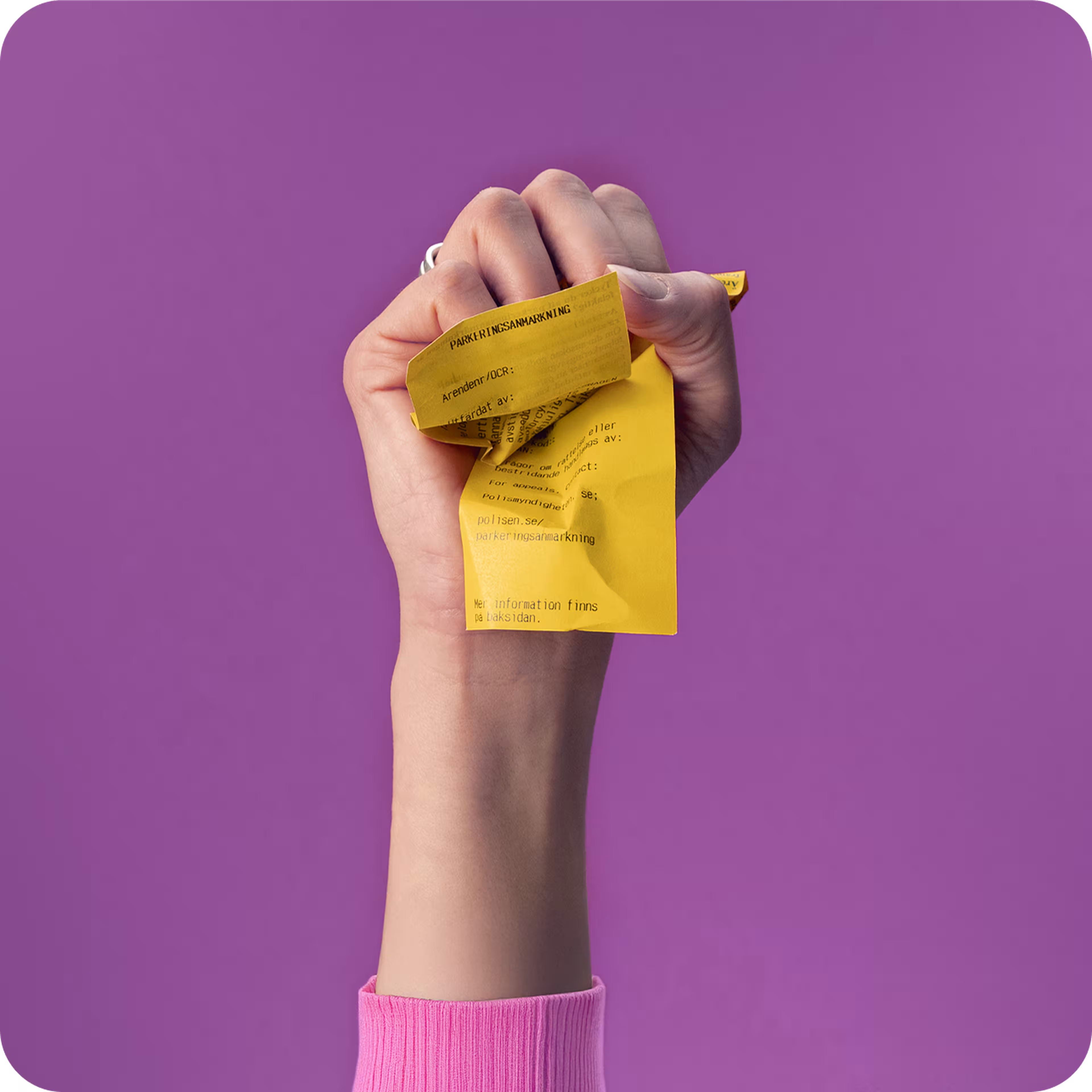A hand clenches a crumpled yellow paper against a purple background.