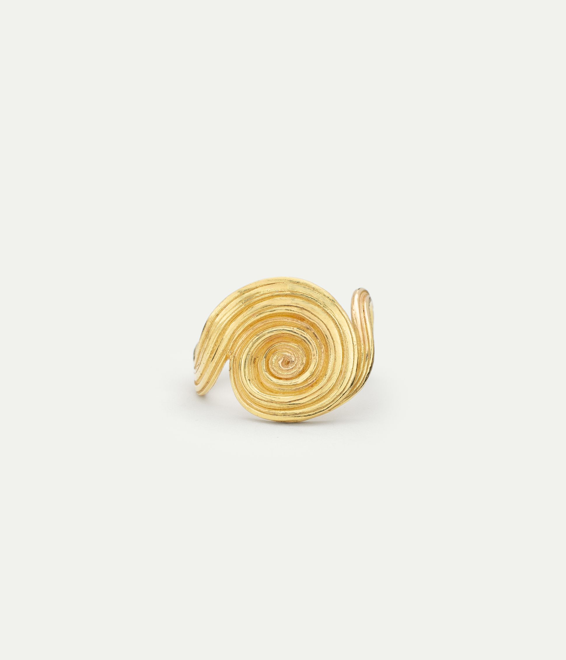 Griegst sculptural gold ring with a spiral design, handcrafted in 18k gold with fluid, textured lines.