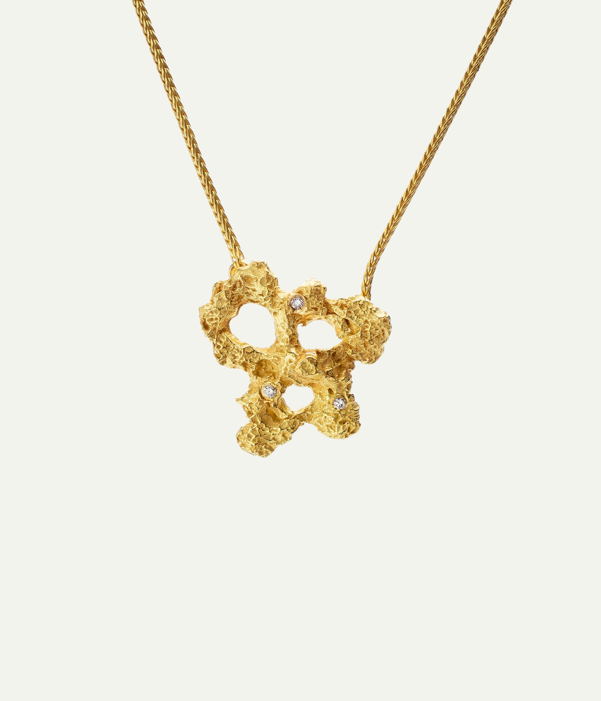Griegst pendant necklace in sculptural 18k gold, featuring an organic, textured form set with diamonds.