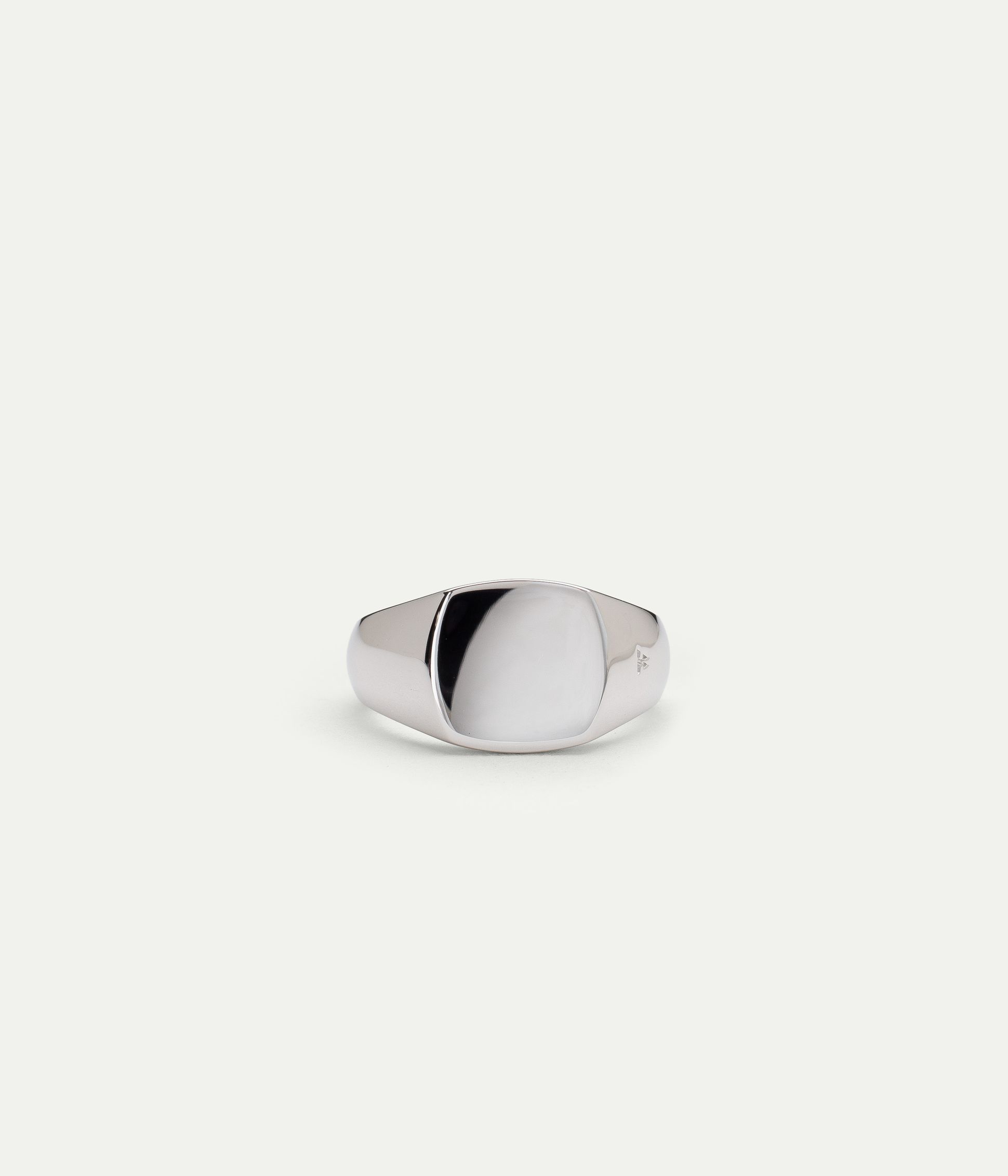 Polished silver signet ring by Tom Wood, minimalist design with a smooth mirror finish.