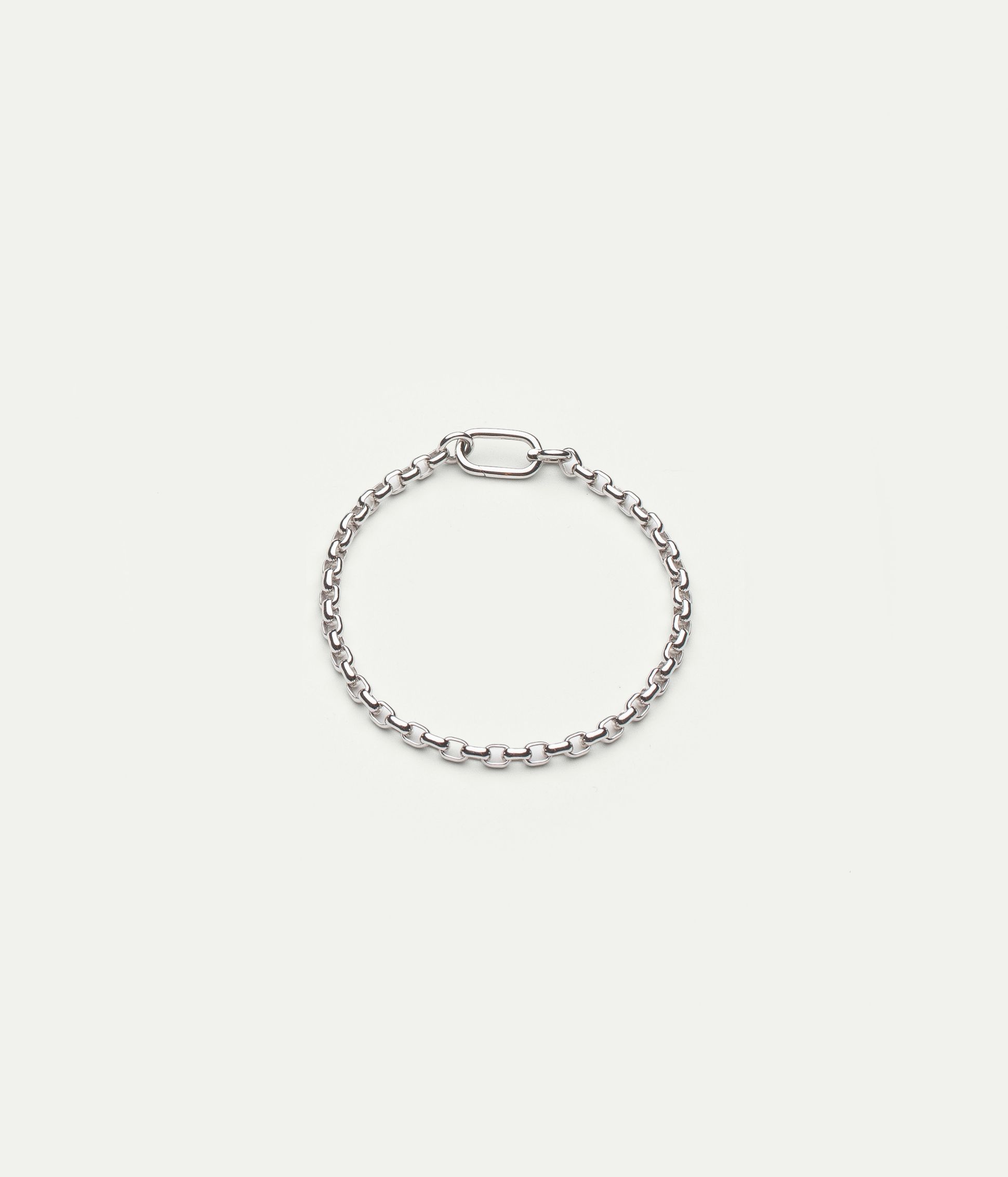 Silver chain bracelet with a rectangular clasp, displayed on a plain white background.