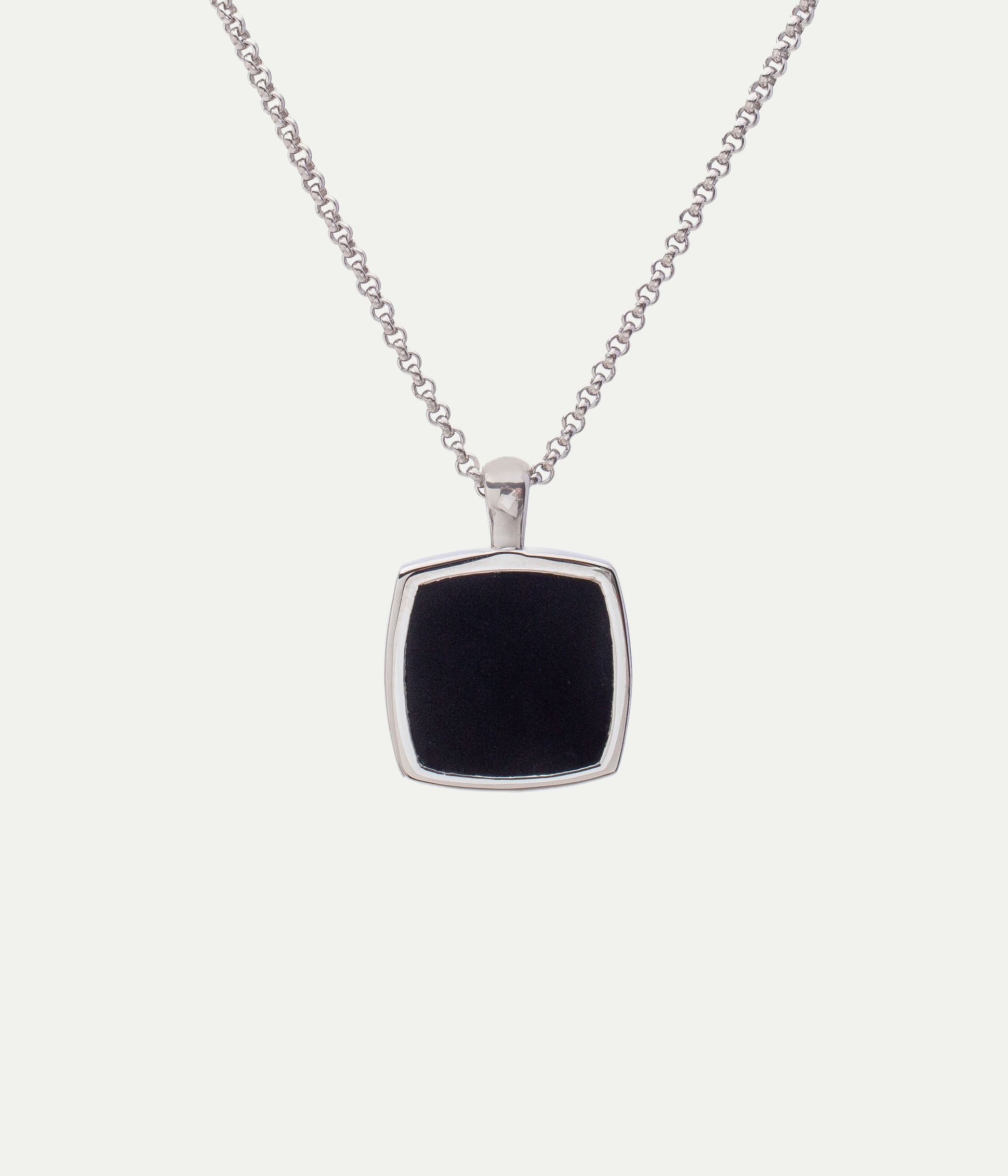 Silver chain necklace with a square black pendant, set in a silver frame, against a plain white background.