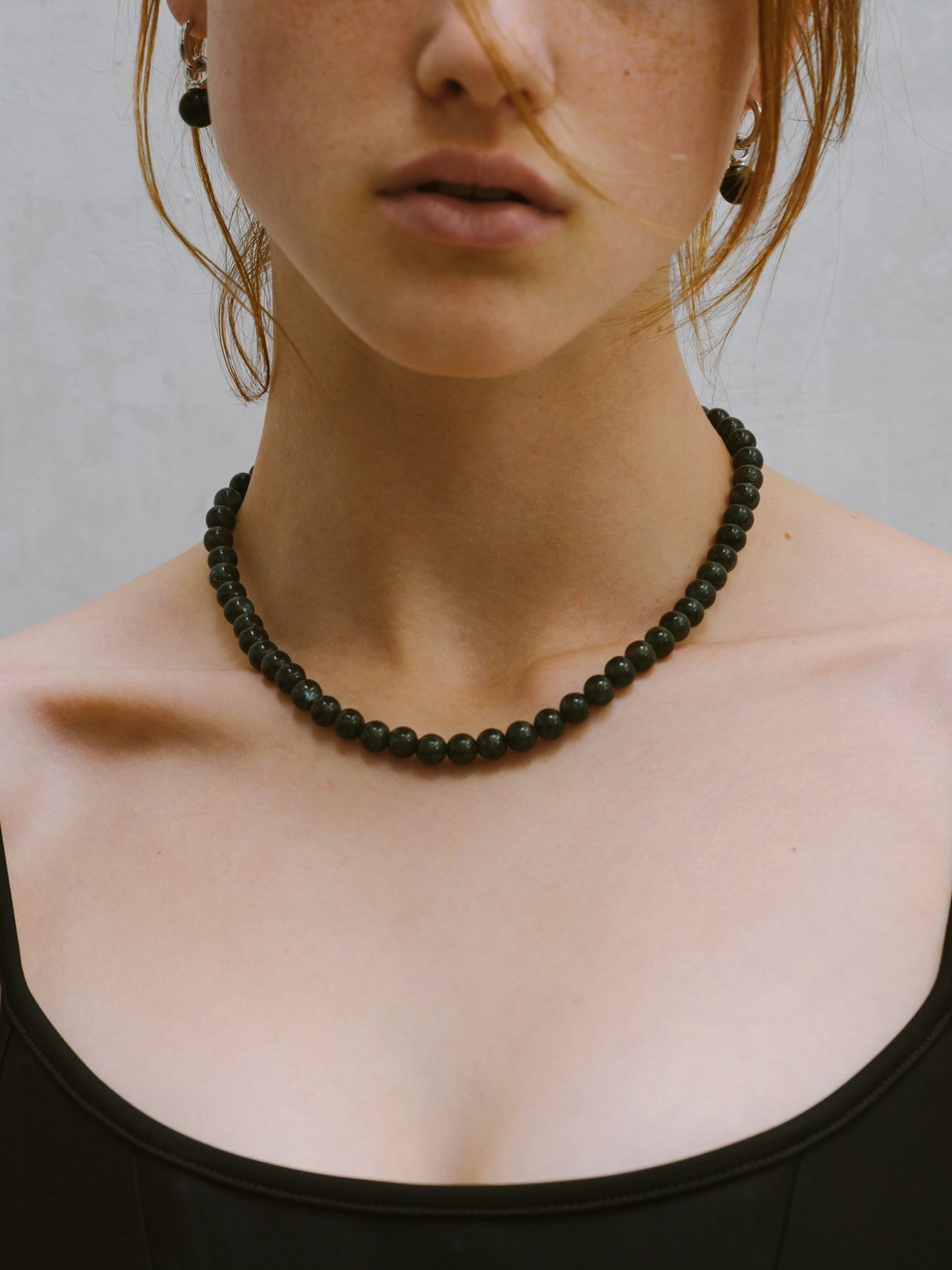 Tom Wood black bead choker necklace worn with a black top, minimalist and timeless style.