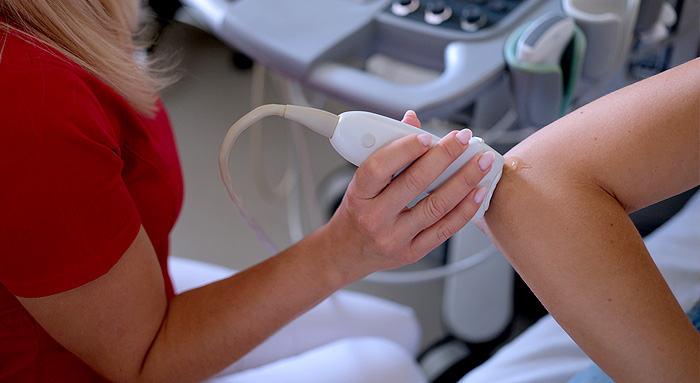 Elbow and forearm being scanned using an ultrasound probe