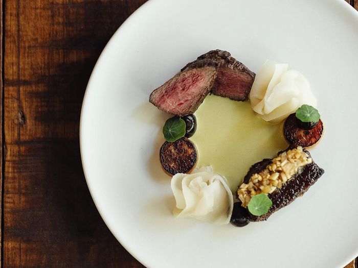 Oyster and short rib main arranged in a wreath