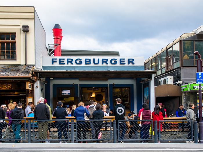 People sitting outside Fergburger in Queenstown