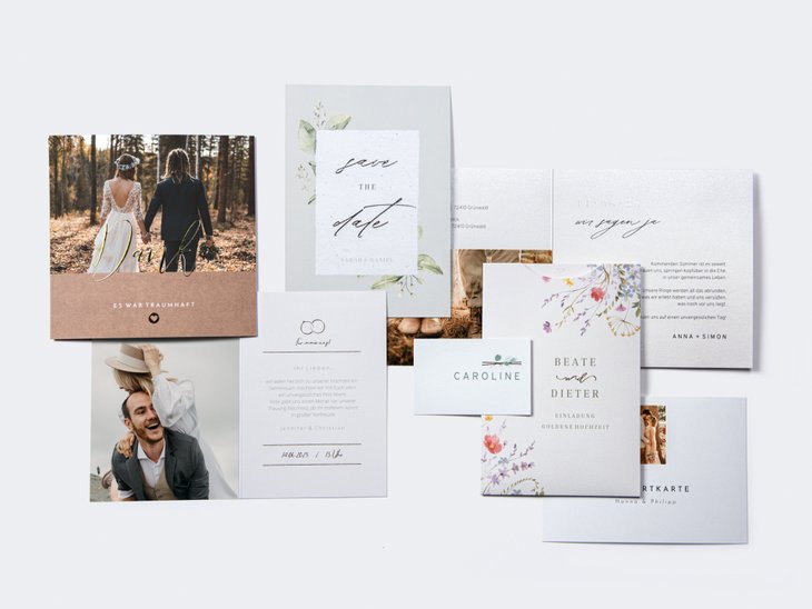 Eine Kollektion eleganter Hochzeitseinladungskarten mit floralen Motiven, Fotos und stilvoller Typografie und Veredelungen auf weißem Hintergrund.