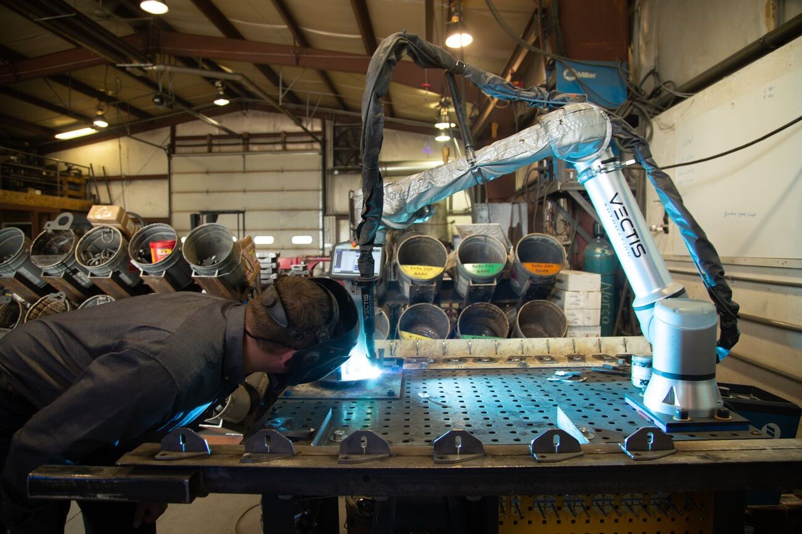 Collaborative robotic welding system with welding torch and work fixture