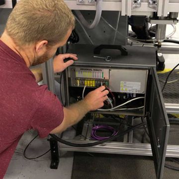 Darex, a manufacturer of drill and knife sharpeners, uses a UR3 cobot from Universal Robots to control the entire assembly line with a conveyor and different sub-stations through the MODBUS communication protocol all handled through the UR cobot’s controller.