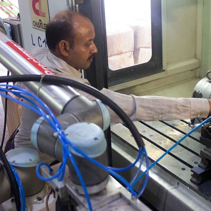 Human alongside with Collaborative Robot UR10 during CNC machine tending application at Shruti Engineers, India