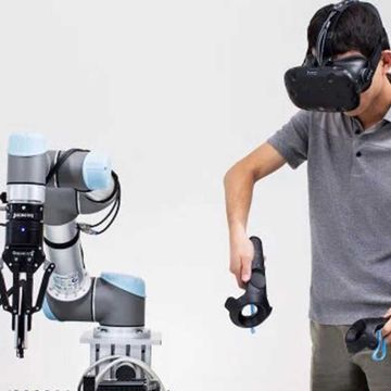 Tianhao Zhang, research scientist at Embodied Intelligence, with a UR3 cobot and Robotiq gripper.