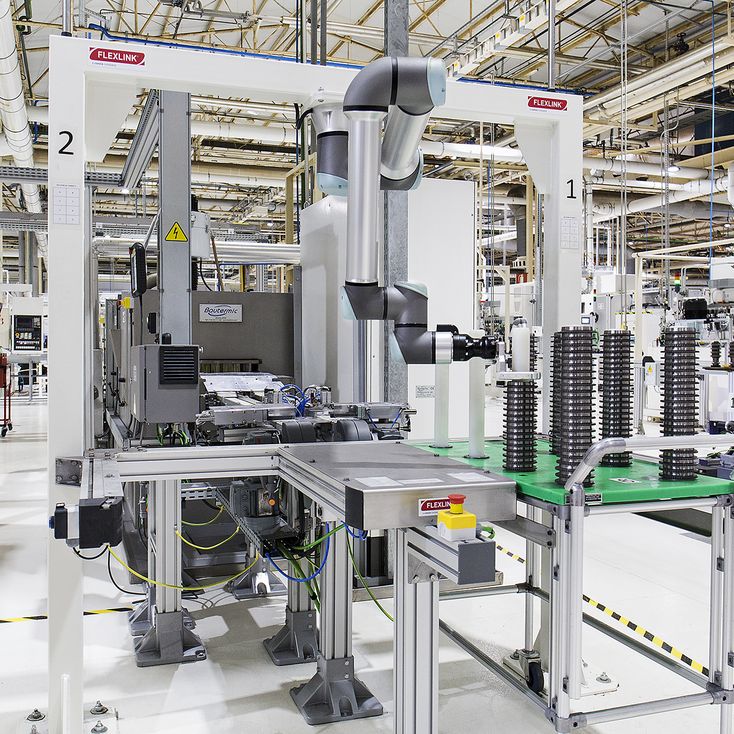 Universal Robots integration cell where SEAT Components uses 11 UR12e cobots to automate unloading of 18,000 machined gears daily.