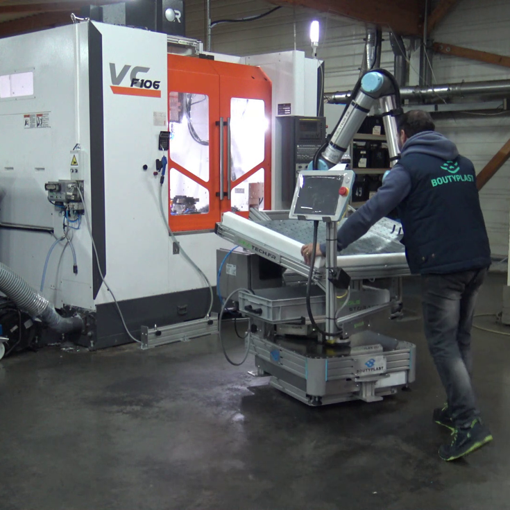 L’opérateur positionne le cobot devant la machine grâce à une plateforme nomade