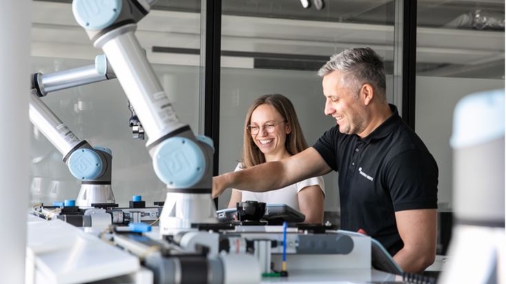 Universal Robots engineers testing a collaborative robot application in a lab environment, validating mechanical, electrical, and software integration for UR+ certification and full compatibility with Universal Robots cobots.