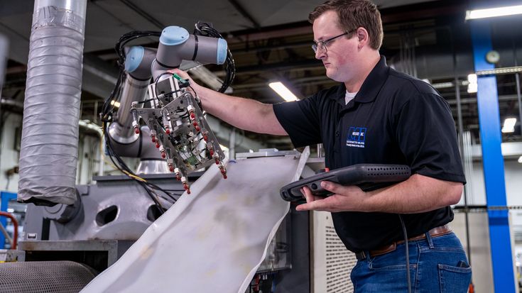 Worker and robot fed machine