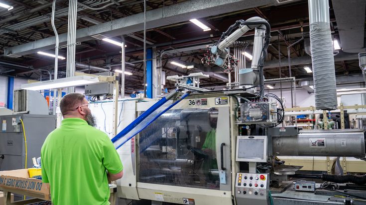 Worker and robot fed machine