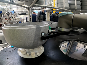 The cobot grabs the sell previously placed by the operator