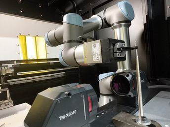 He places it on a mechanical centering device for precise engraving at the desired location