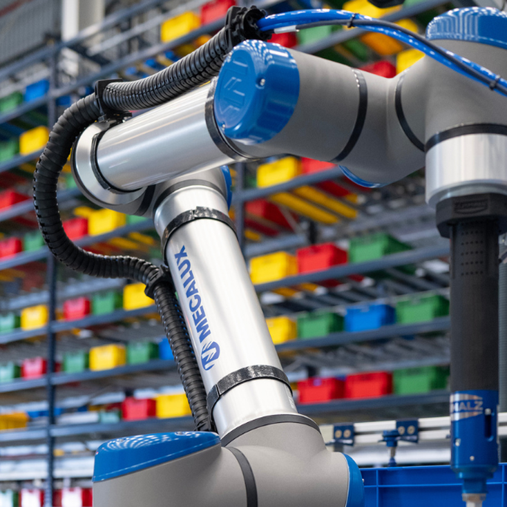Collaborative robot arm performing automated picking in a warehouse with organized storage bins