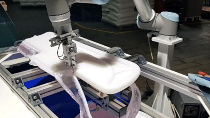 Einer unserer Cobots schneidet bei Pepri ein blasgeformtes Teil für ein Krankenhausbett.