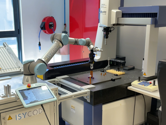 Après s’être saisi d’un joint, le cobot le déposé sur la plateforme d’opération pour que la machine de mesure commence son activité
