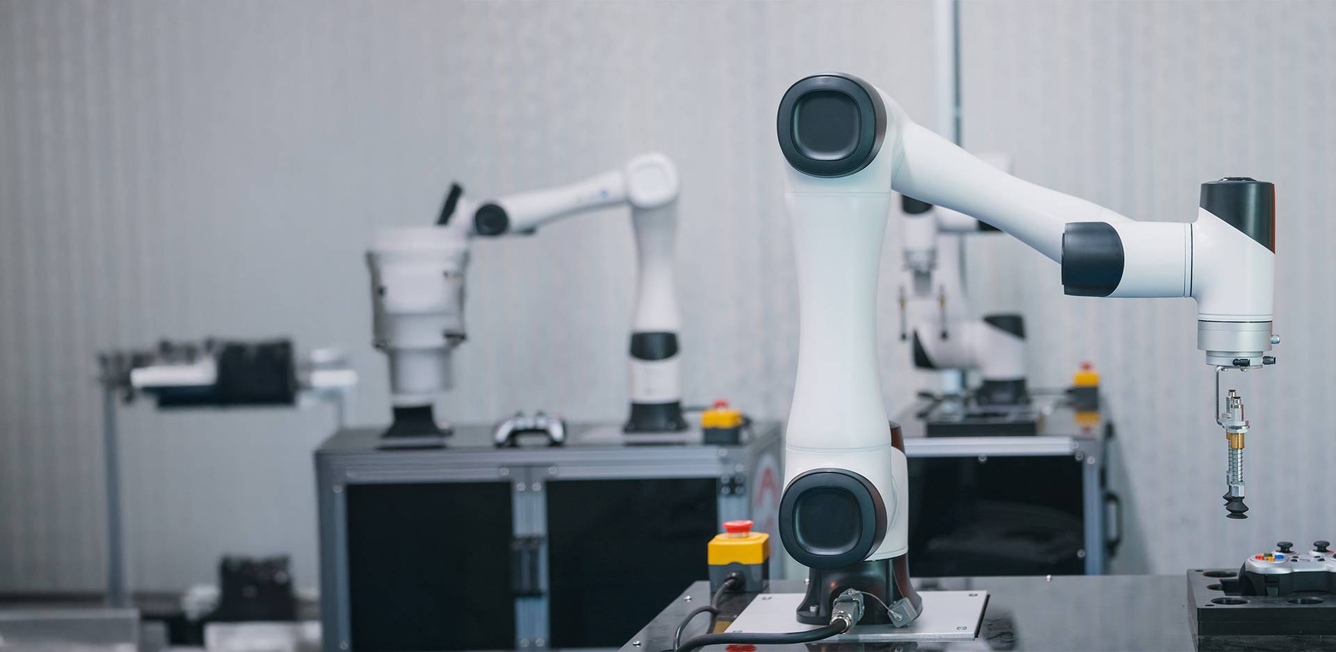 Industrial robot arms in an automated production environment, equipped with precise grippers, on a stable table.