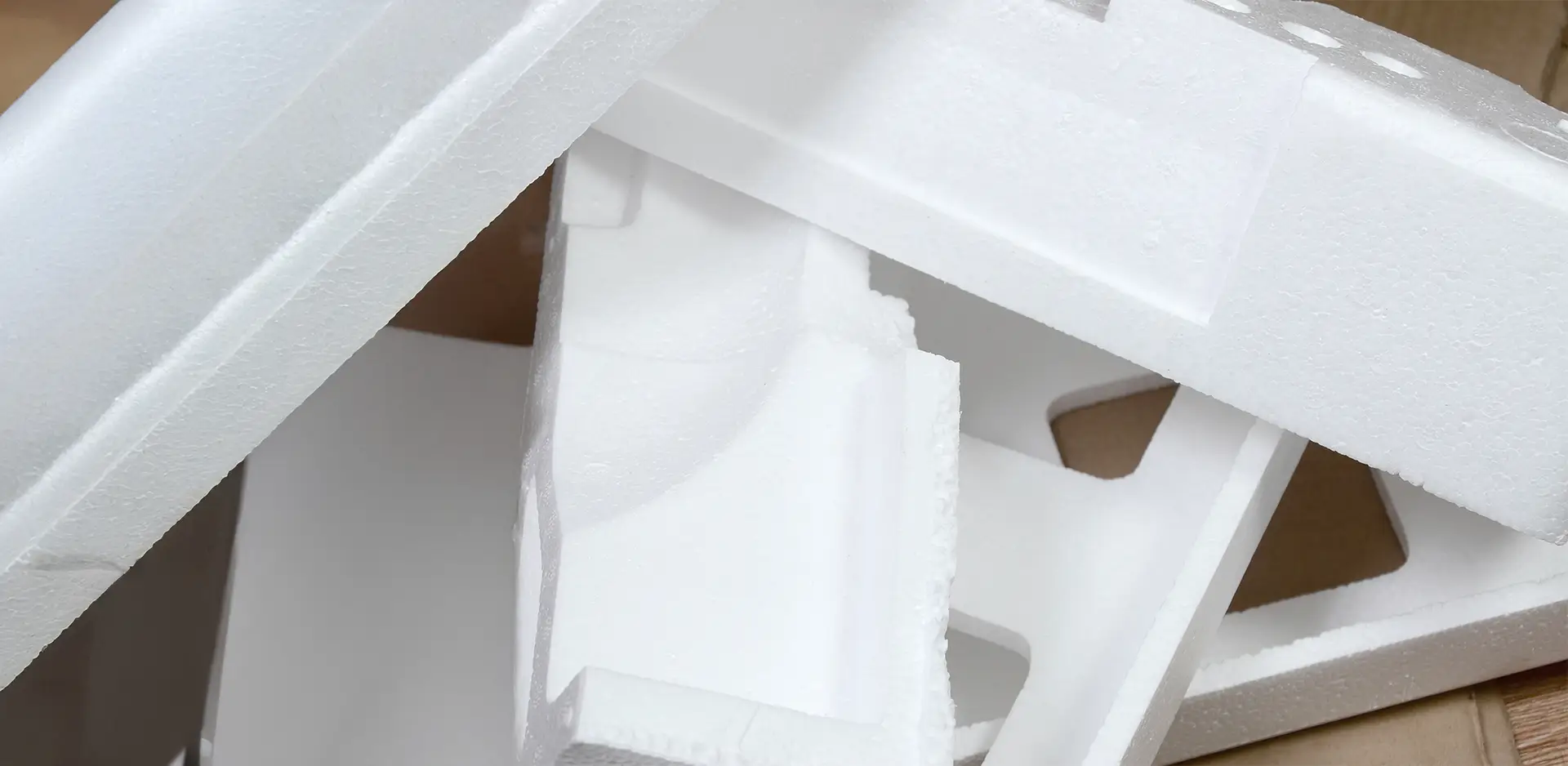 Close-up of white expanded polystyrene (EPS), also known as Styrofoam, in the form of packaging elements. Ideal for shock-absorbing packaging, insulation, and lightweight components.