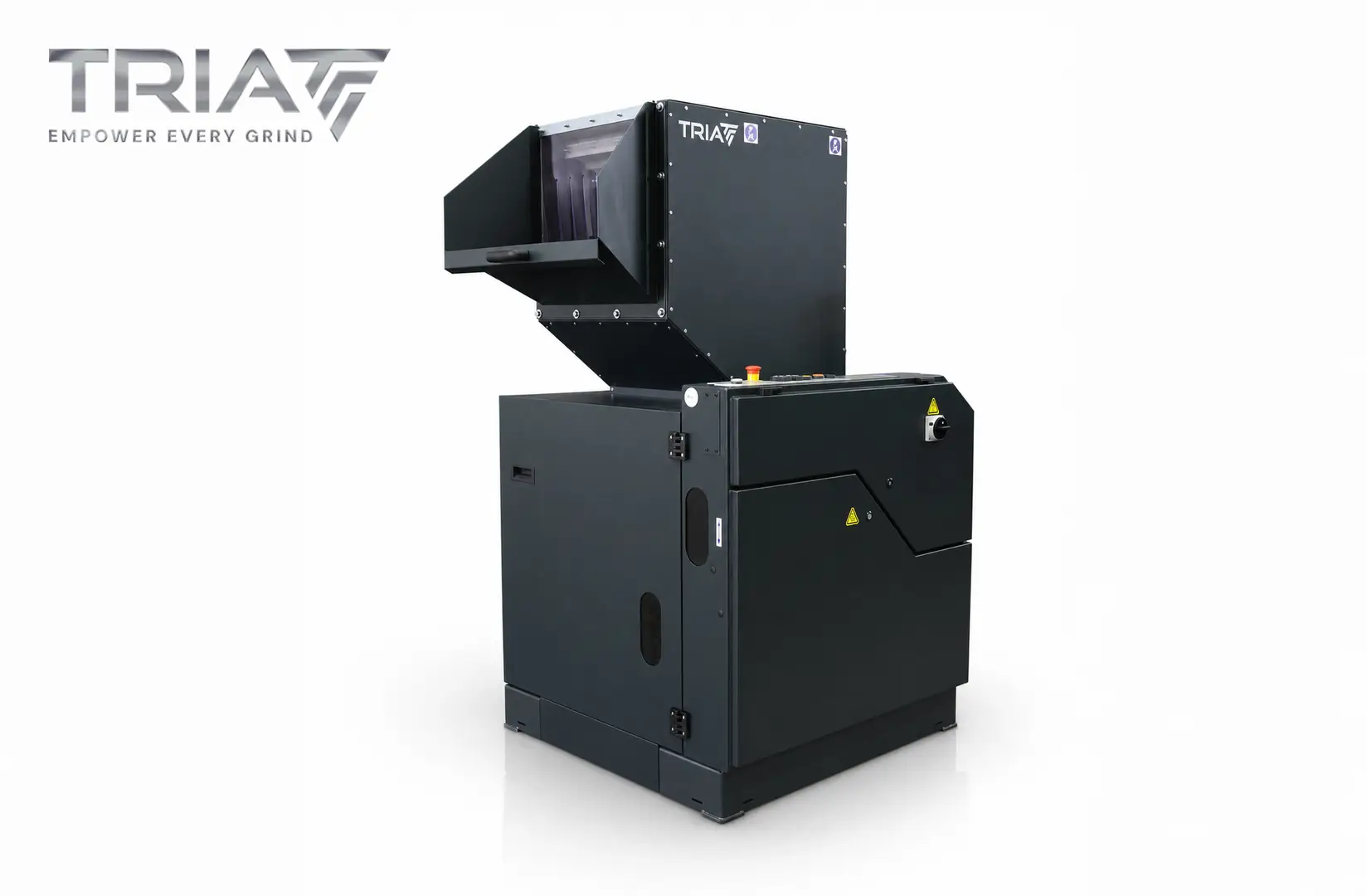 Large industrial granulator with TRIA logo, featuring a hopper and control panel, used for grinding or recycling materials.