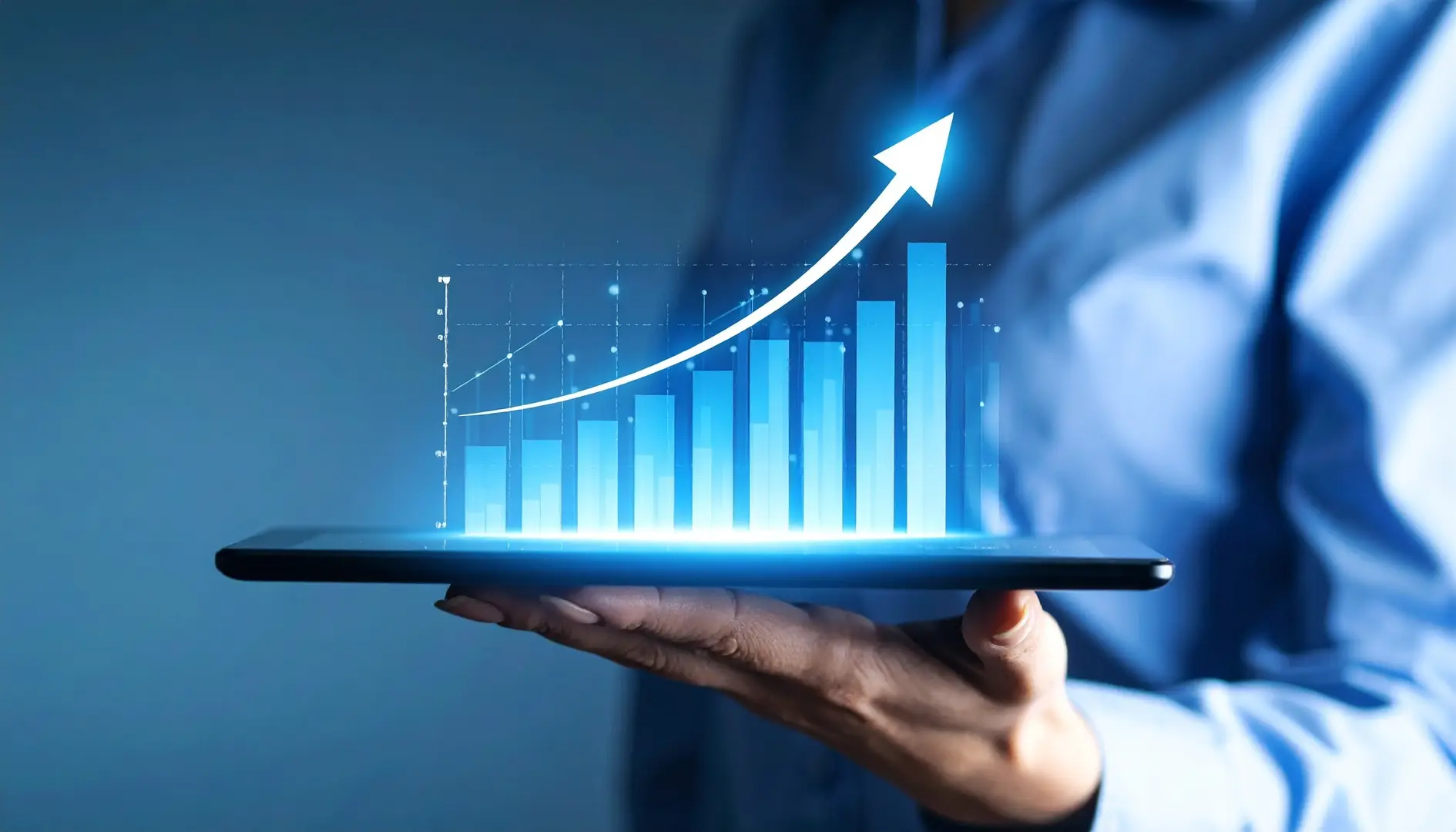 Person holding a tablet displaying a glowing bar graph with an upward arrow, symbolizing growth or success.
