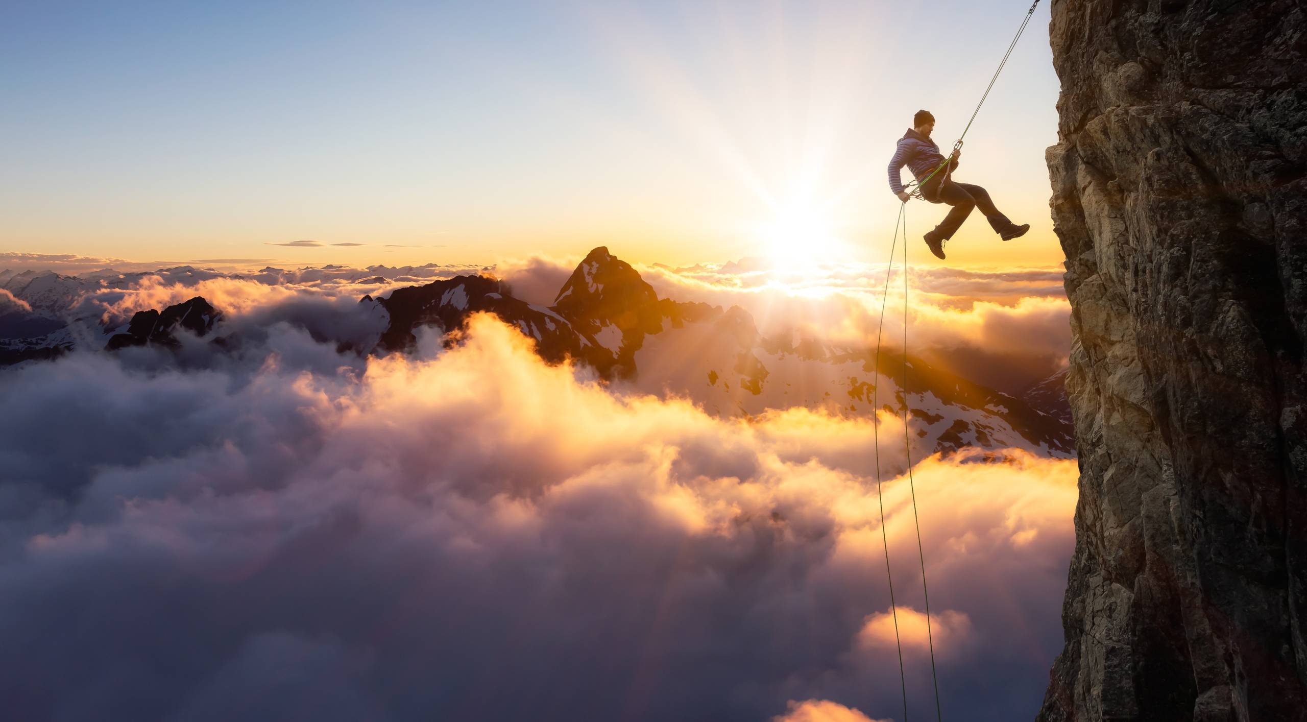 wide shot of a mountain climber with rope