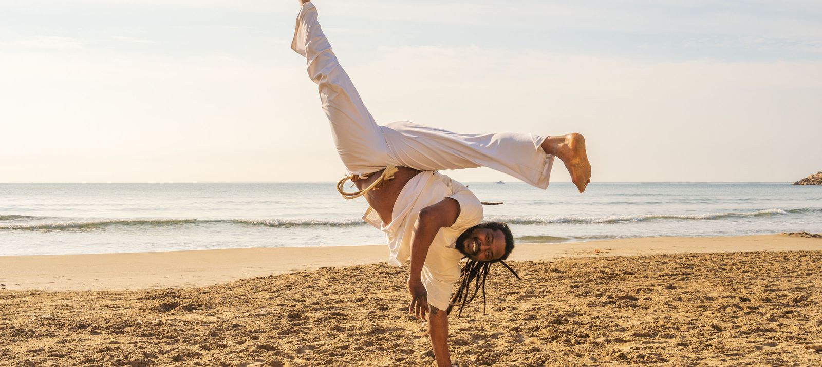capoeira dancer on beach
