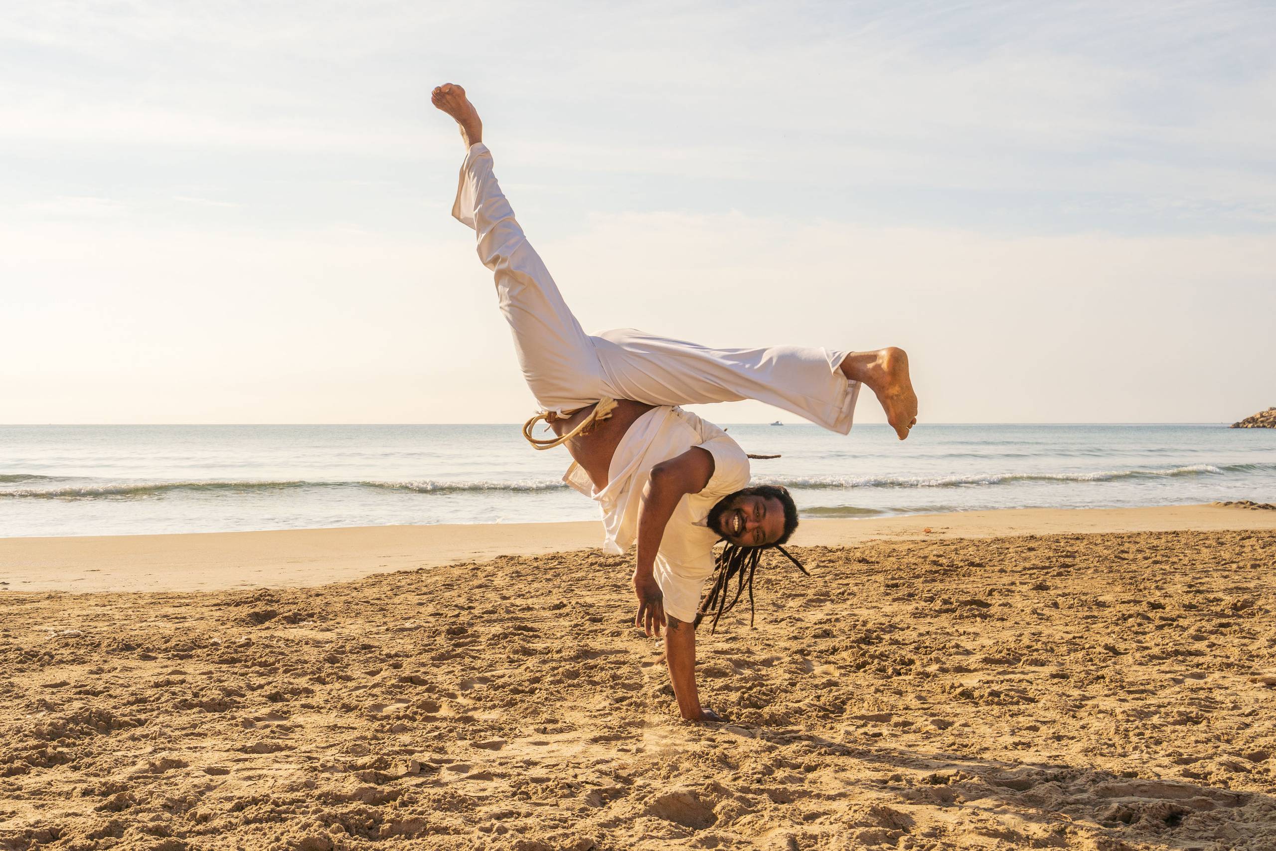 capoeira dancer on beach