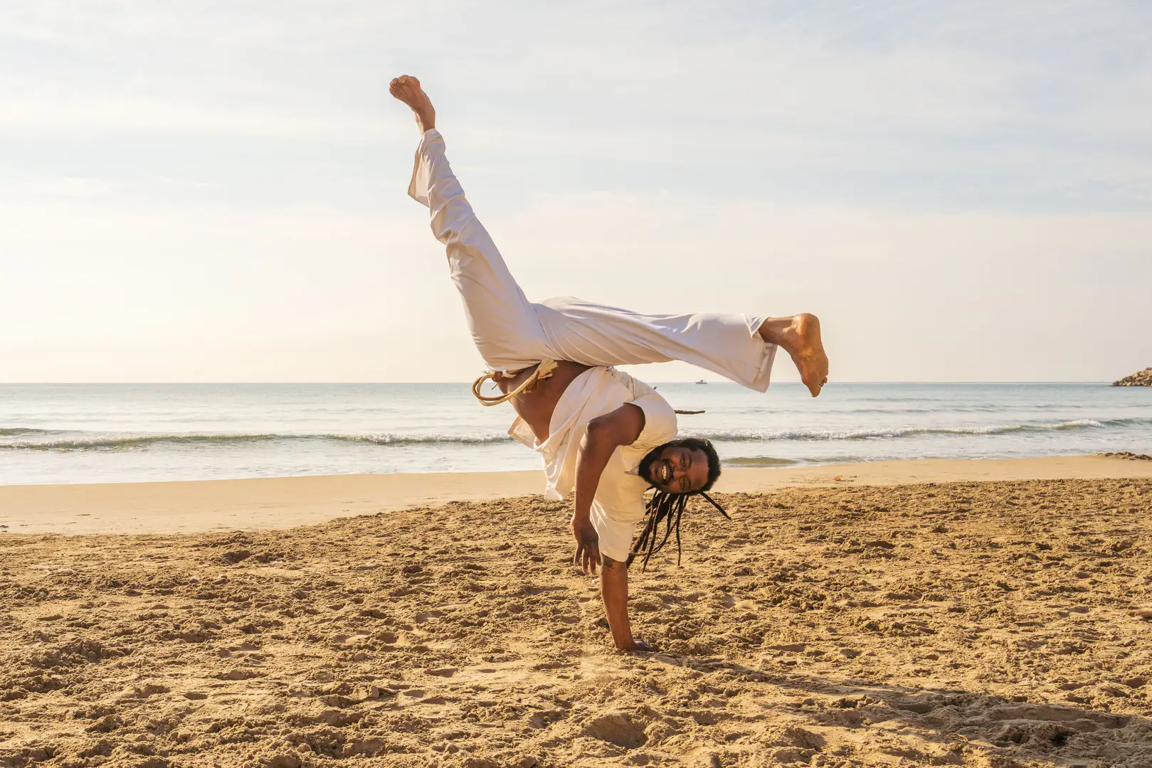 capoeira dancer on beach