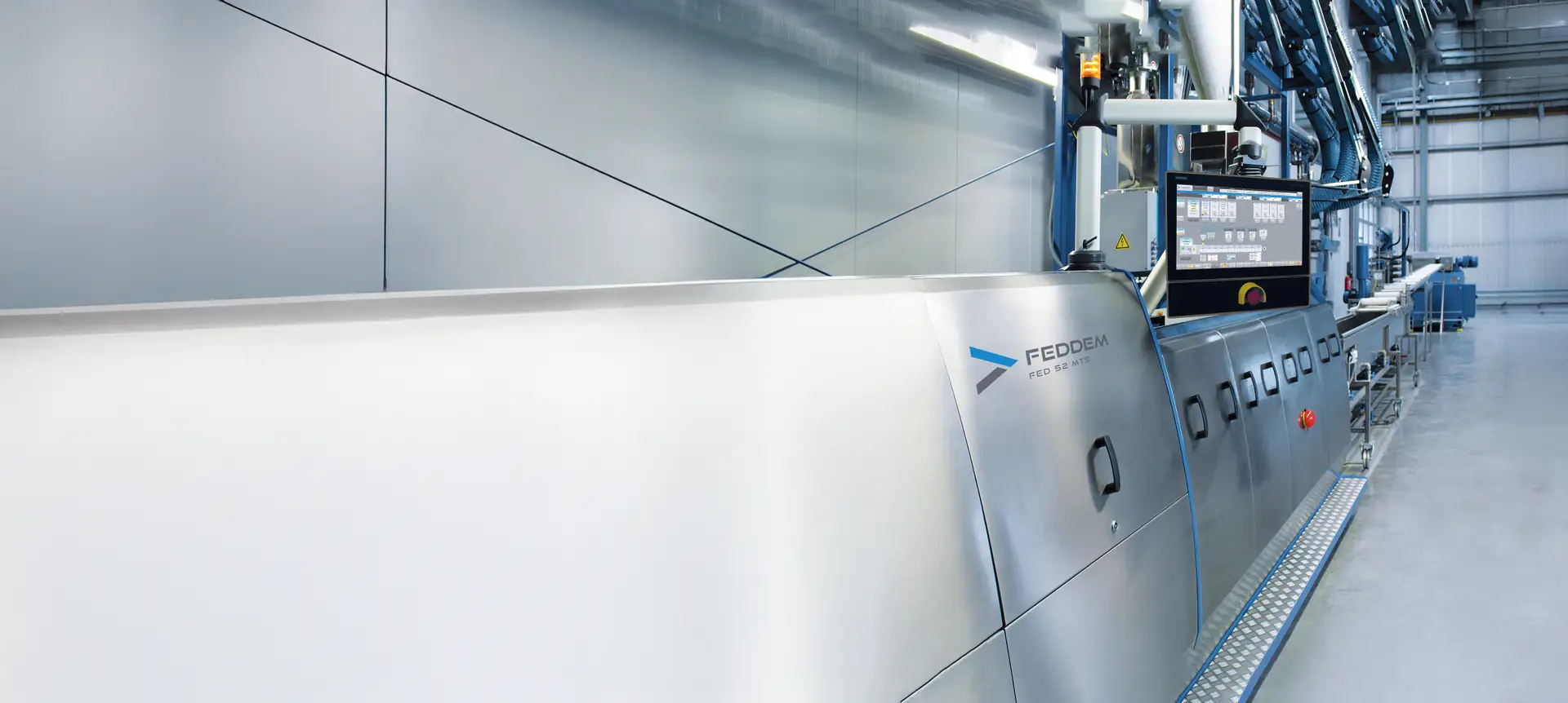 Die vollständige Compoundierlinie von Feddem mit dem FED 52 Extruder in einer modernen Produktionshalle, ausgestattet mit Wasserbad für präzise Stranggranulierung und effiziente Herstellung hochwertiger Polymergranulate.