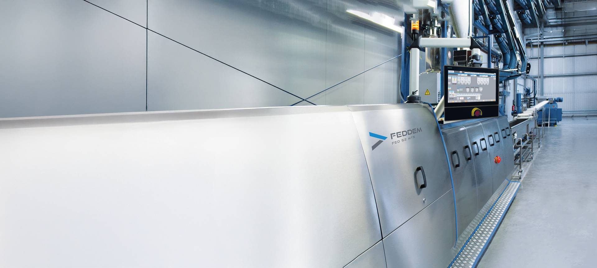The complete Feddem compounding line featuring the FED 52 extruder in a modern production facility, equipped with a water bath for precise strand pelletizing and efficient manufacturing of high-quality polymer pellets.