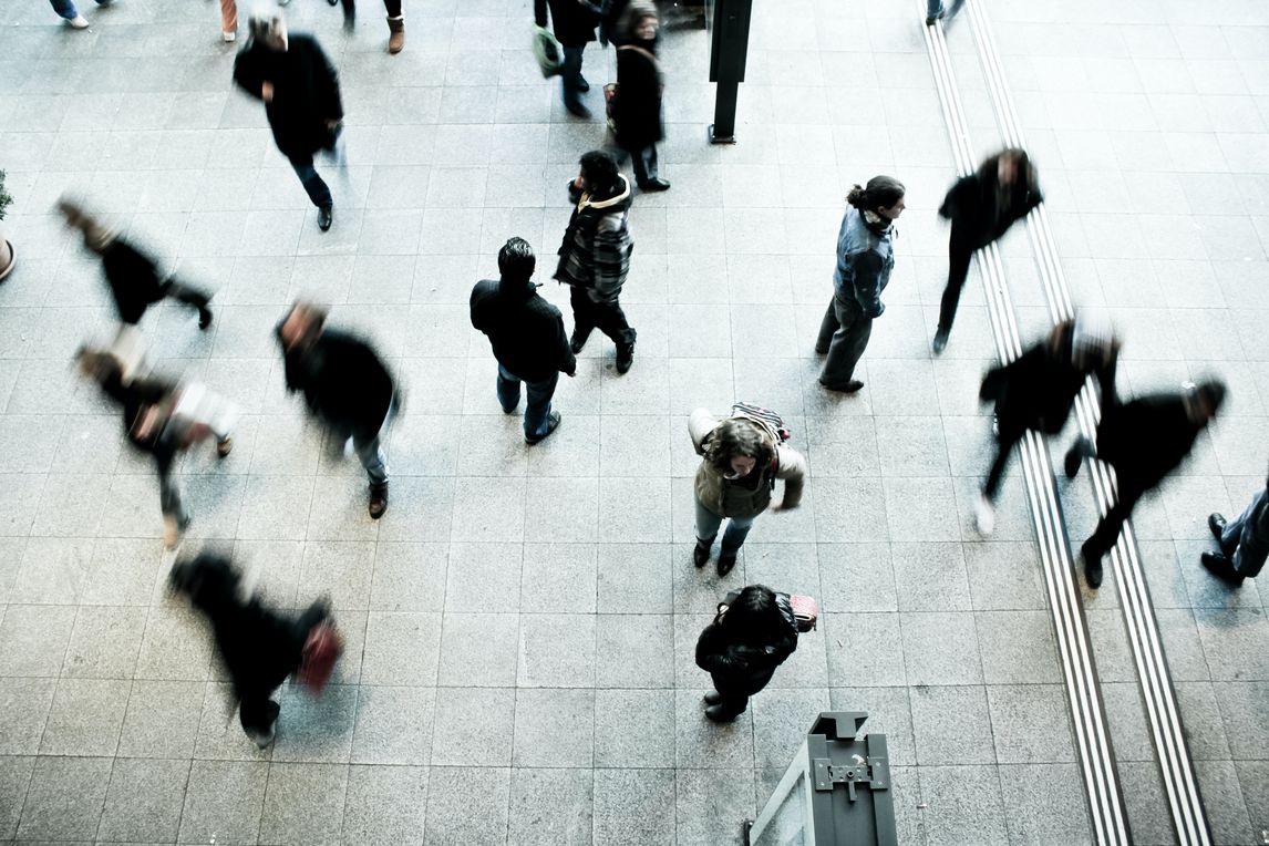 People passing by at a train station
