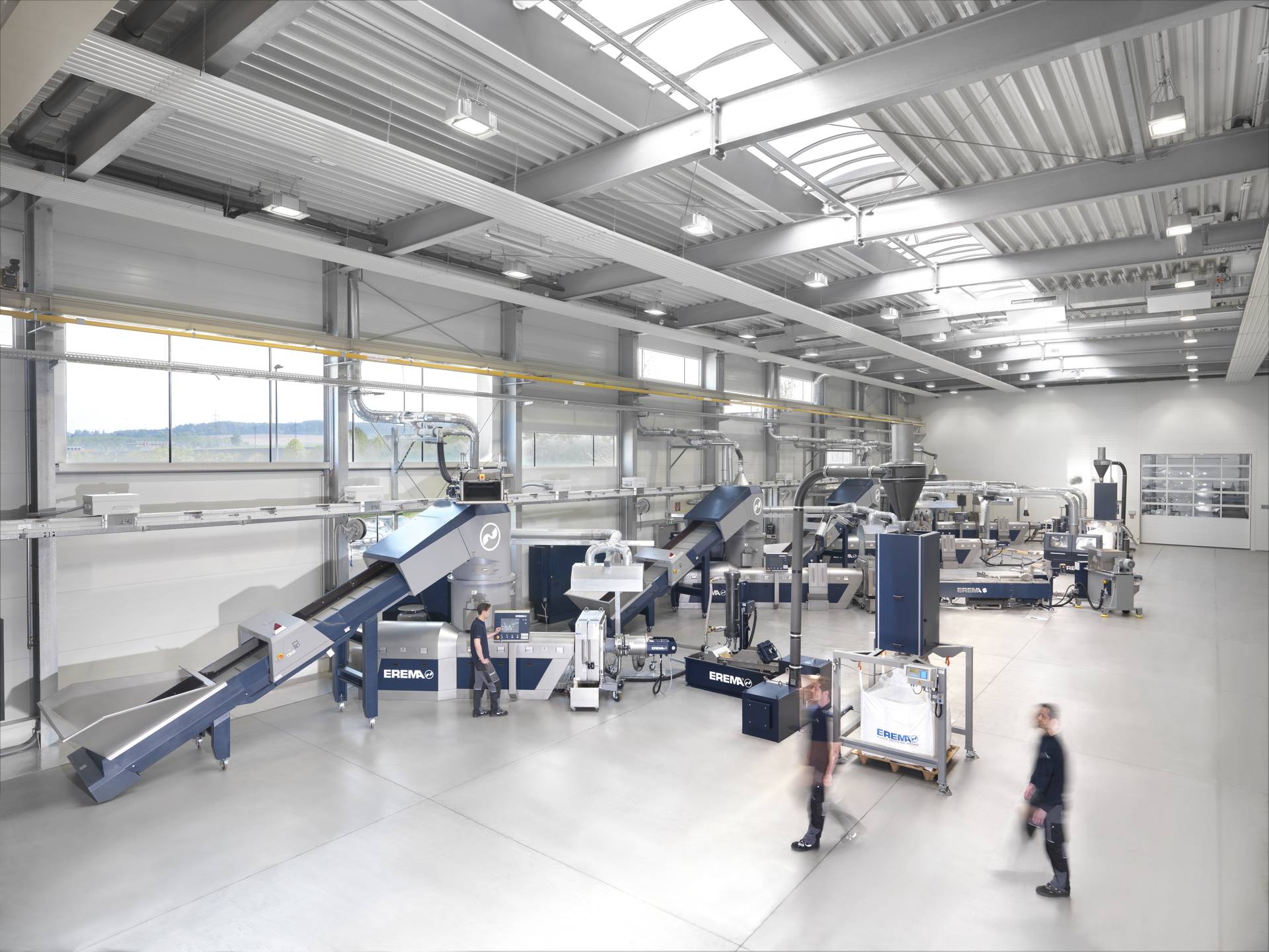 EREMA recycling system in operation, showcasing advanced plastic recycling technology with high efficiency and precision.