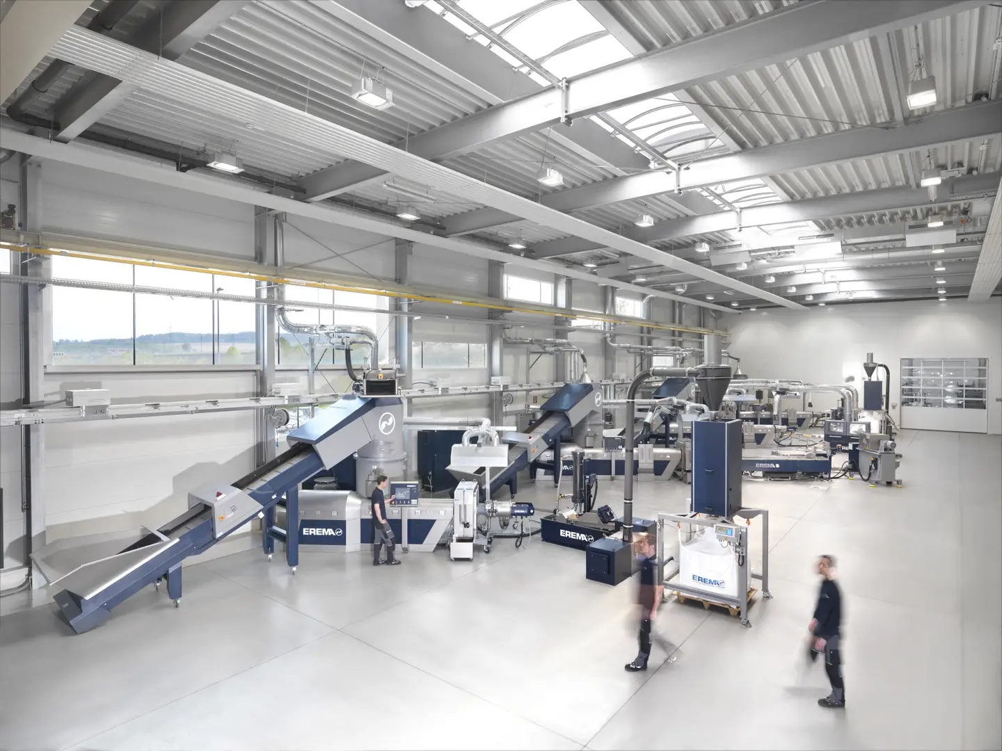 EREMA recycling system in operation, showcasing advanced plastic recycling technology with high efficiency and precision.