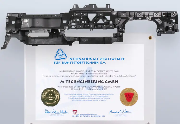 Plaque with "Automotive Award 2021" text and logos, mounted with a black plastic automotive component above it.